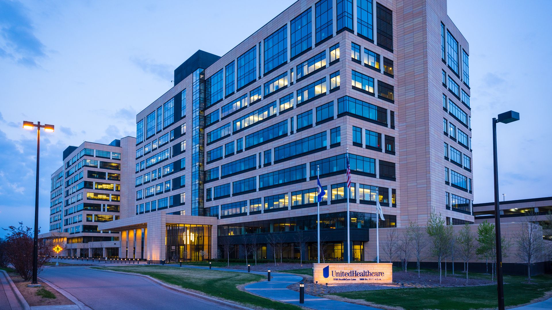 A building with a UnitedHealthcare sign in front at nighttime