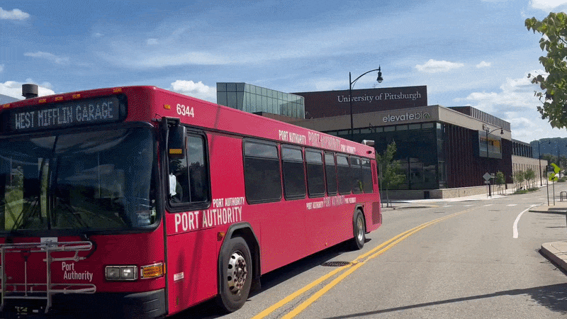 A bus riding by and then view of two large buildings in Pittsburgh's Hazelwood Green neighborhood