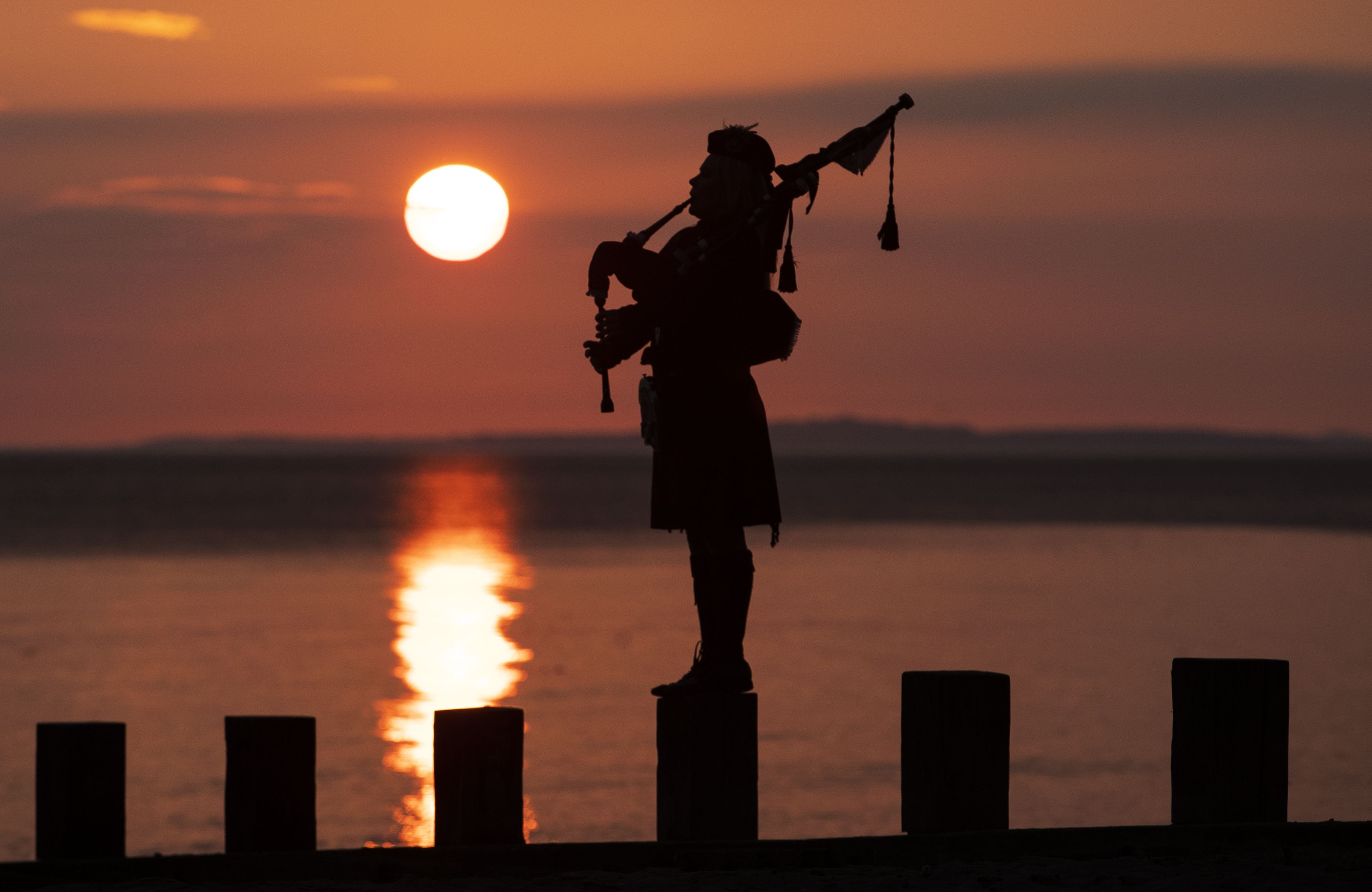 Piper Louise Marshall plays at dawn along Edinburgh's Portobello Beach