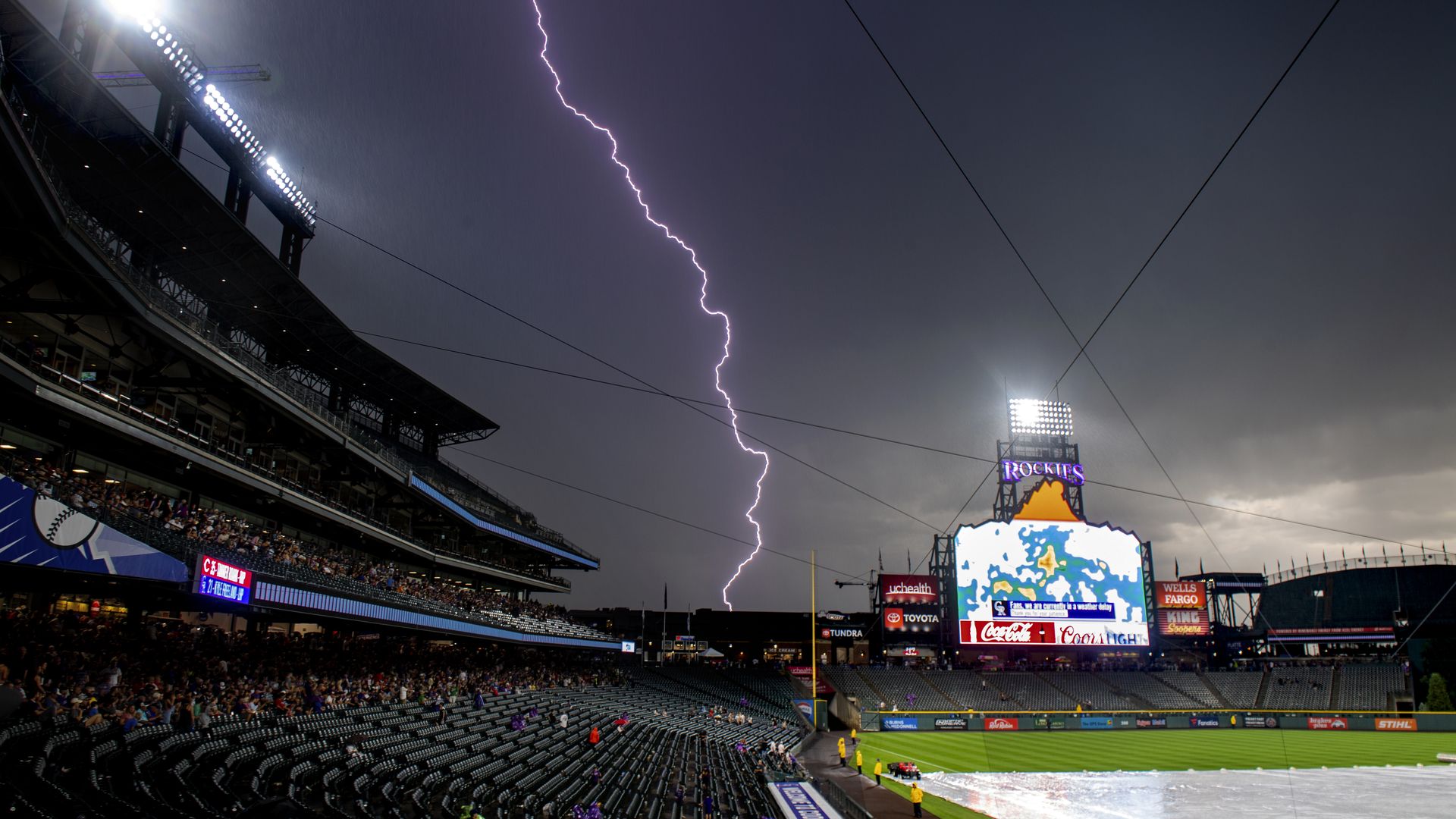 Lightning strikes behind Coors Field during a rain delayed game in July 2019. Photo: Julio Aguilar/Getty Images