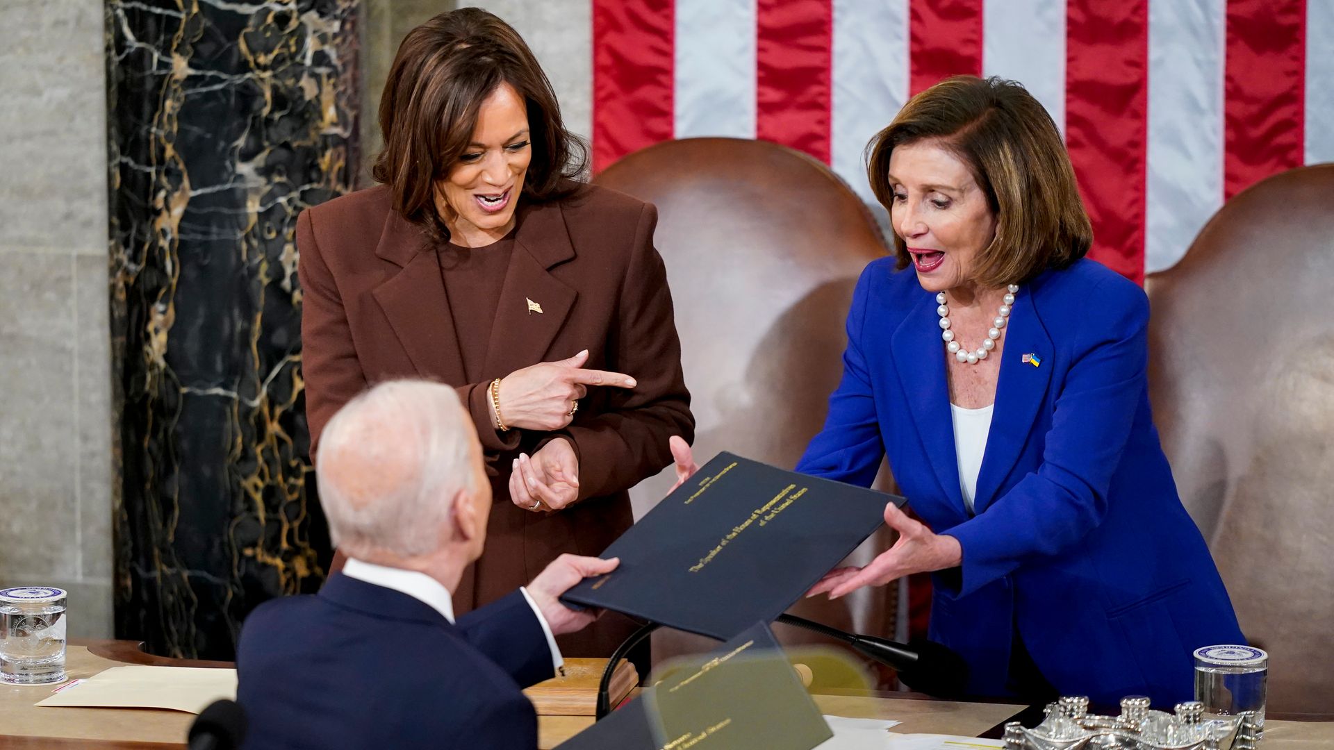 President Biden is seen presenting a copy of his State of the Union address to House Speaker Nancy Pelosi.