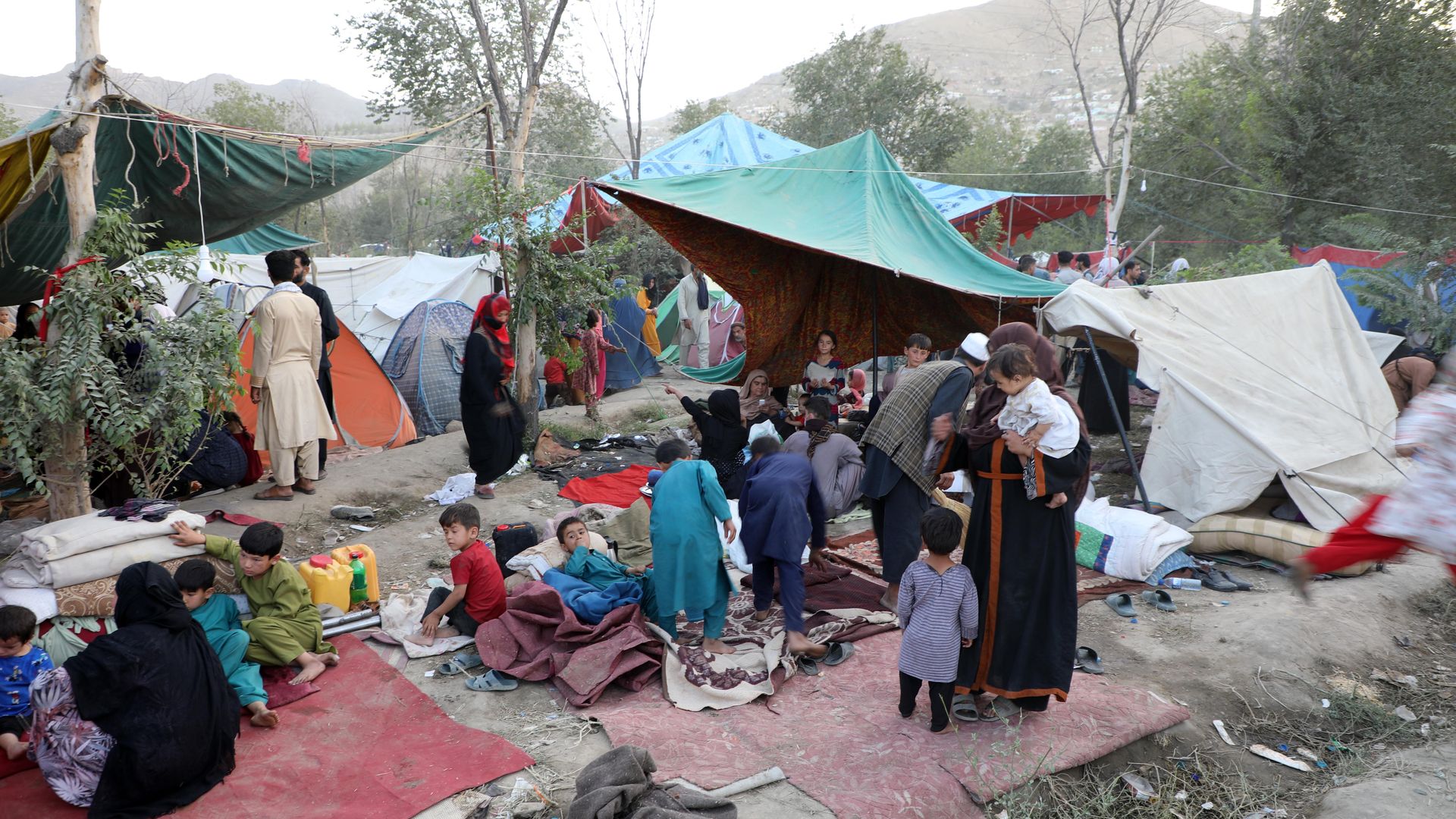 Displaced Afghan families in a makeshift shelter in Kabul, Aug. 10