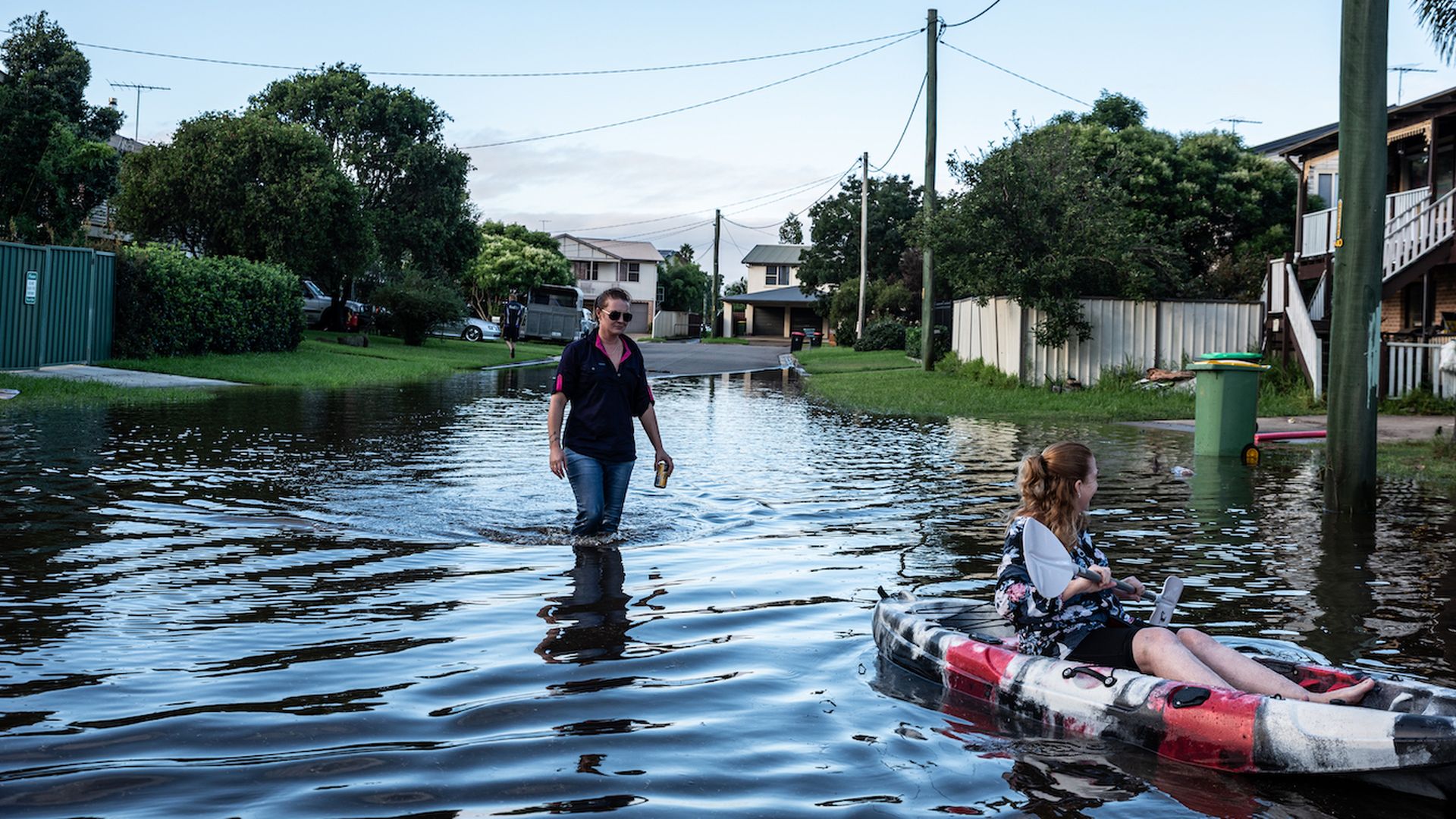 Residents of western Sydney navigate through floodwaters.