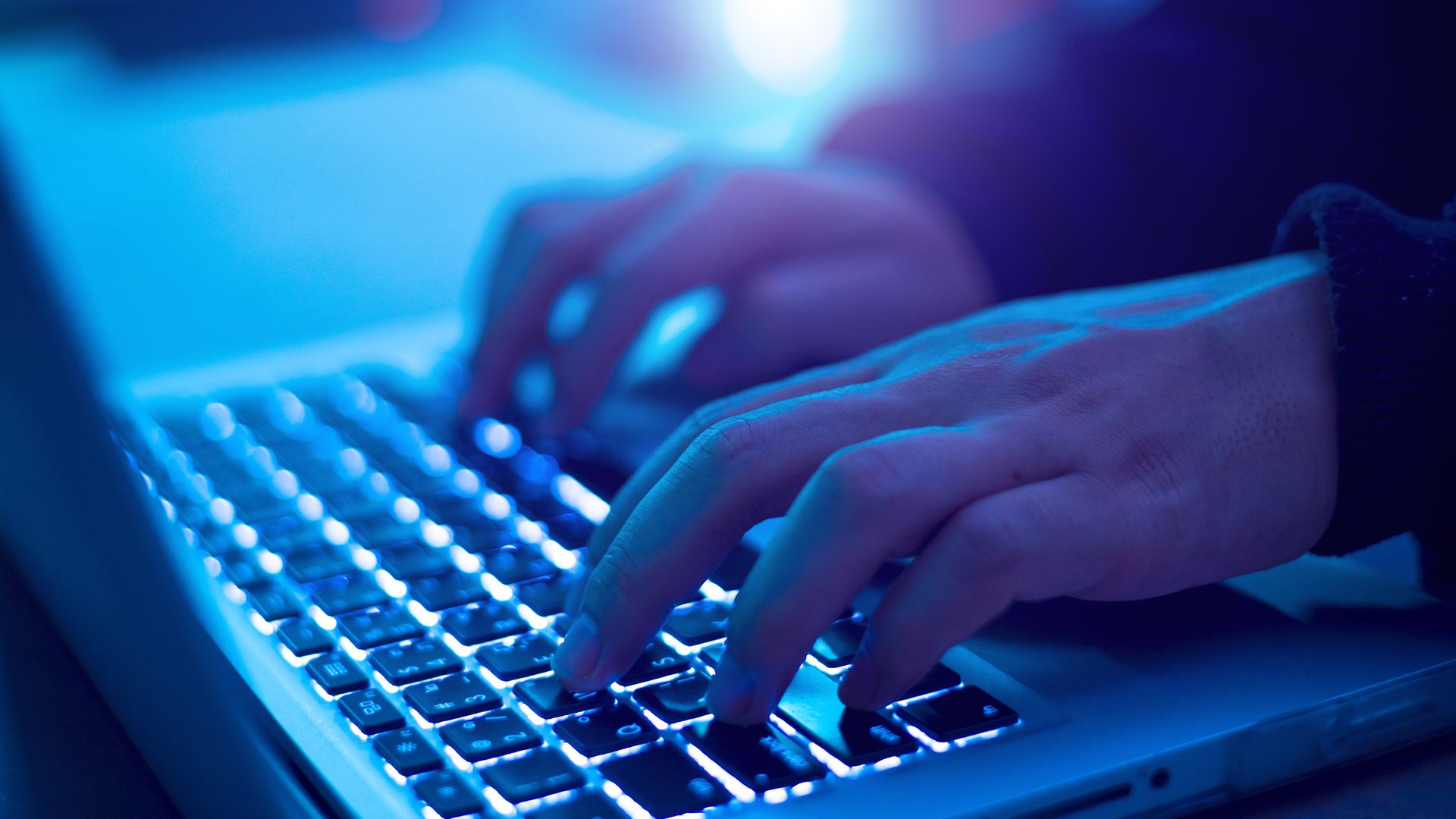 Hacker typing at a computer