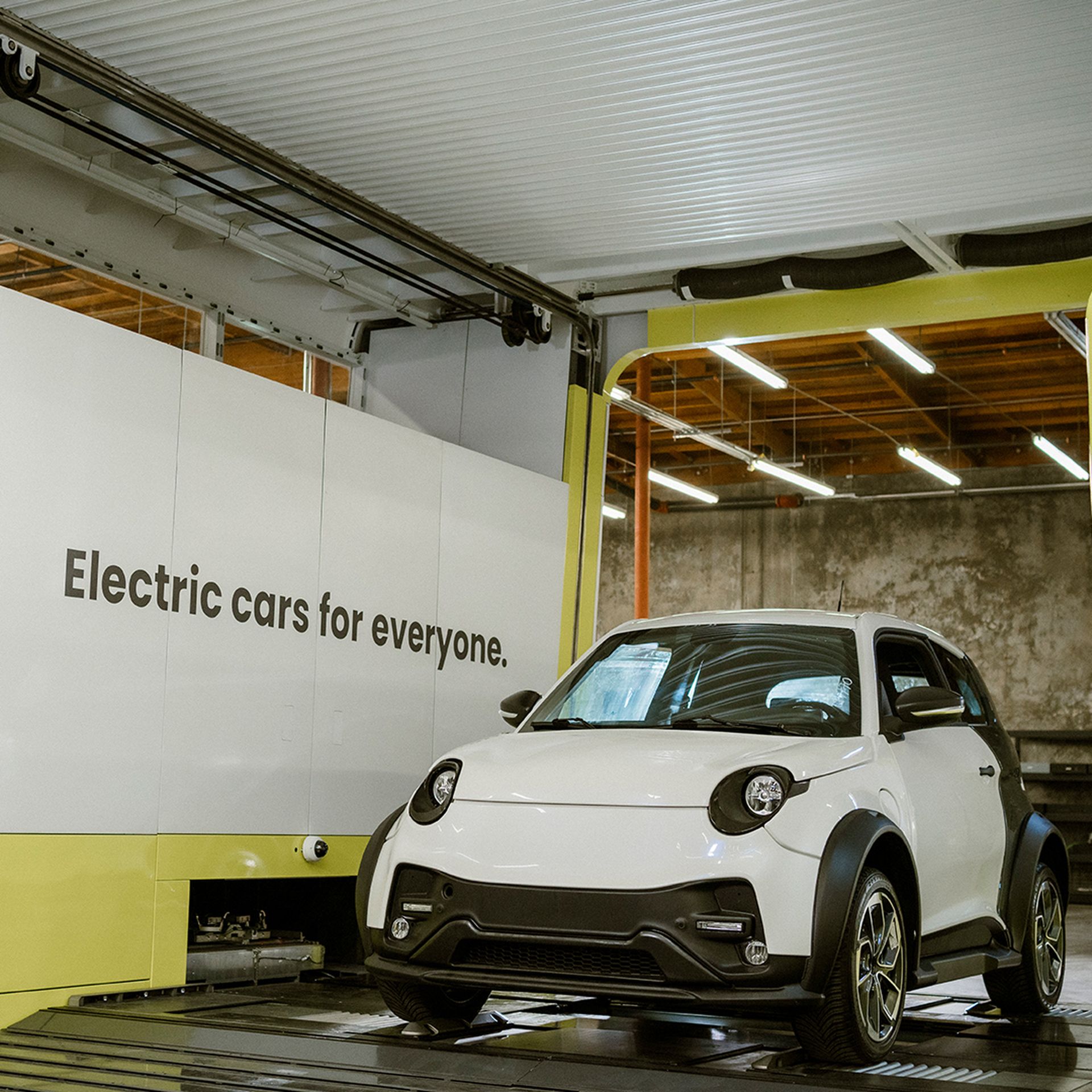 A photo of an electric car parked inside one of Ample's quick battery-swapping stations. 