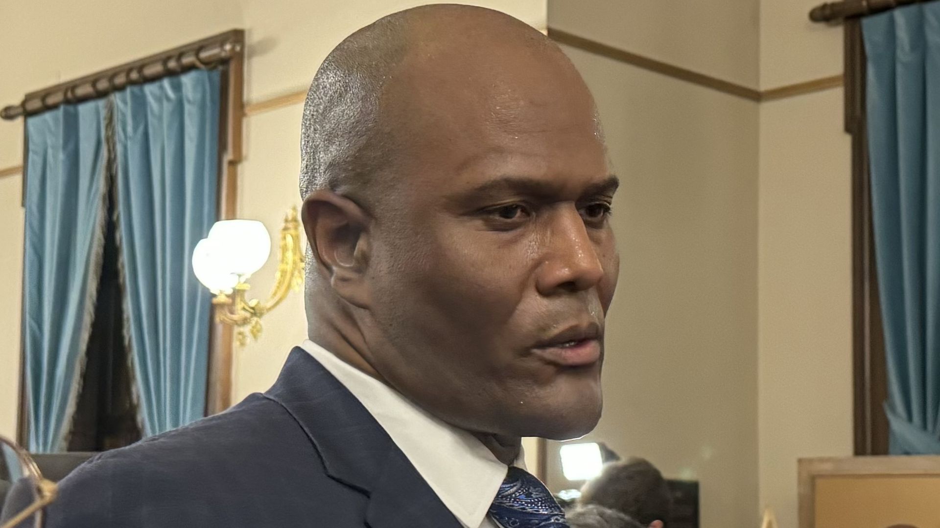 House Speaker Joe Tate (D-Detroit) answers questions from reporters earlier this year inside the state Capitol building in Lansing.