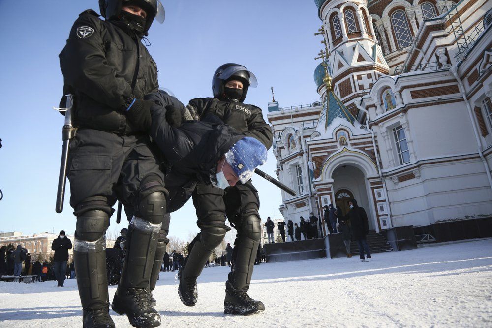 Police detain a man during a protest against the jailing of opposition leader Alexei Navalny in the Siberian city of Omsk, Russia, on Sunday, Jan. 31, 2021. (AP Photo)