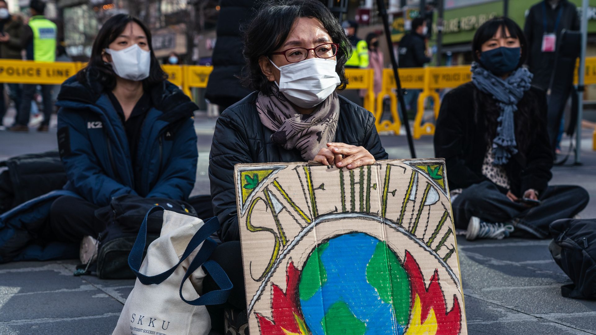 A protestor wearing a face mask displays a placard reading 'Save The Earth' during the climate crisis protest in Seoul. Photo: Simon Shin/SOPA Images/LightRocket via Getty Images