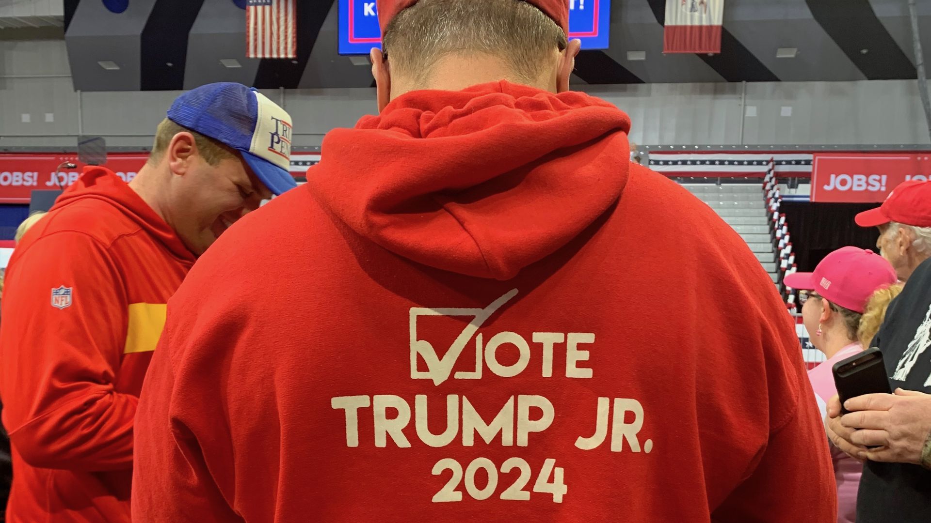 Man wearing a sweater saying vote for Trump Junior in 2024.