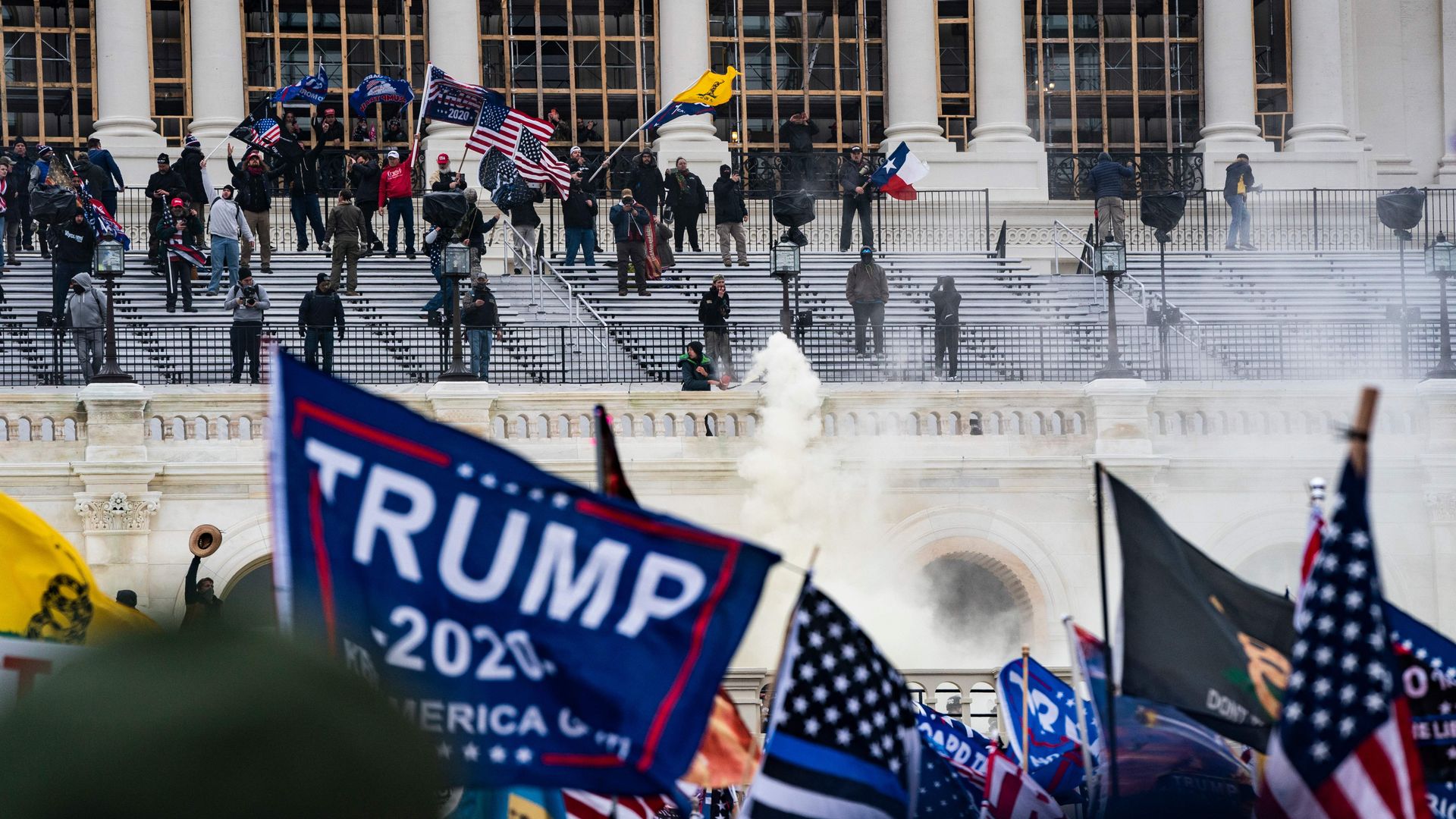 Rioters wave flags on the steps of the US Capitol on January 6.