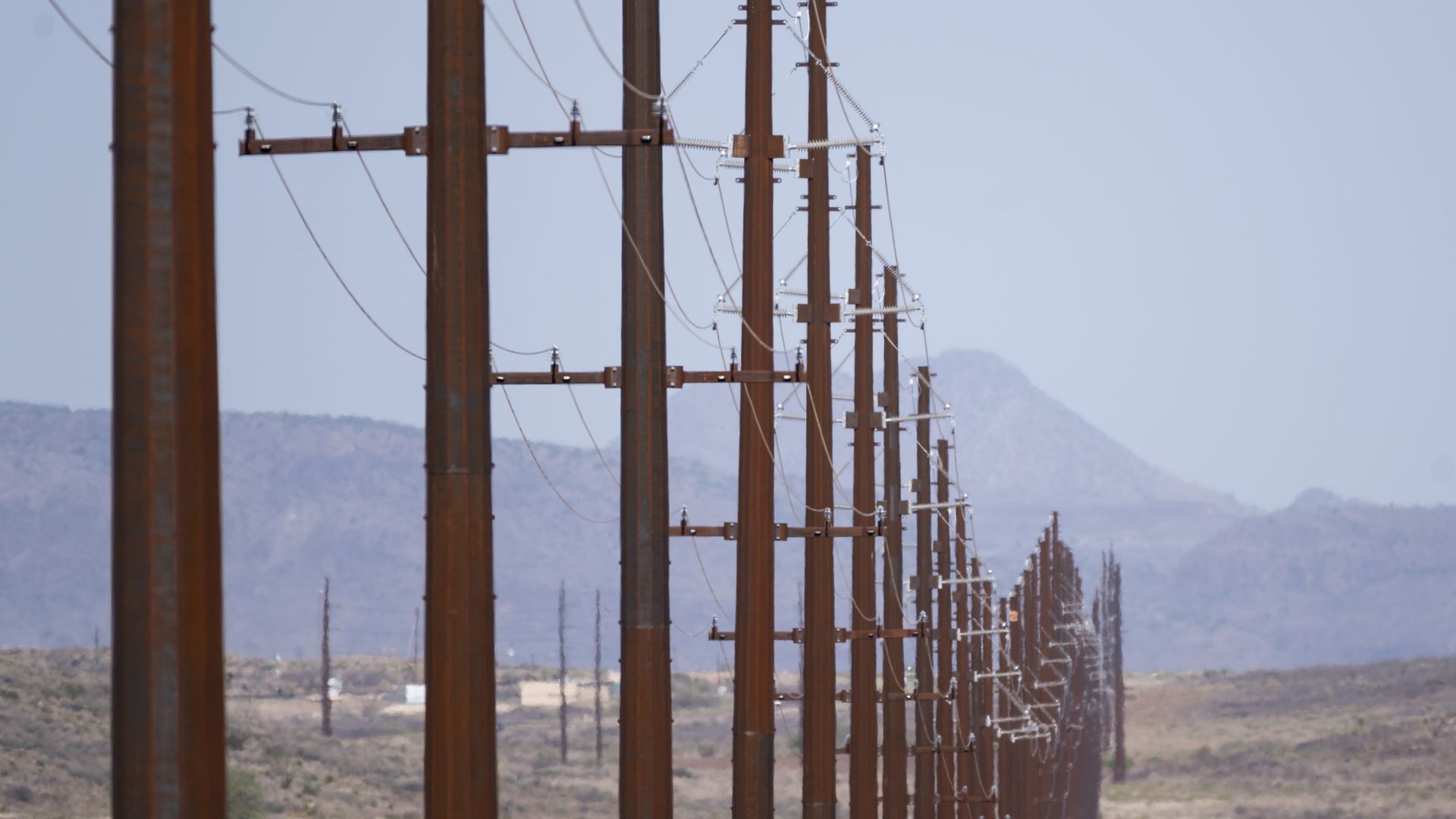 Power lines stretch along along a highway near Alpine, Texas on Saturday, April 10, 2021.
