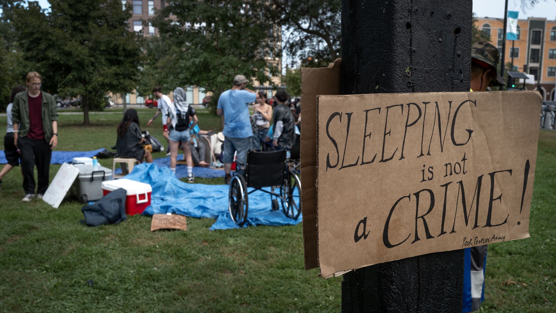 Sleeping is not a crime sign in front of demonstrators ahead of Chicago's DNC