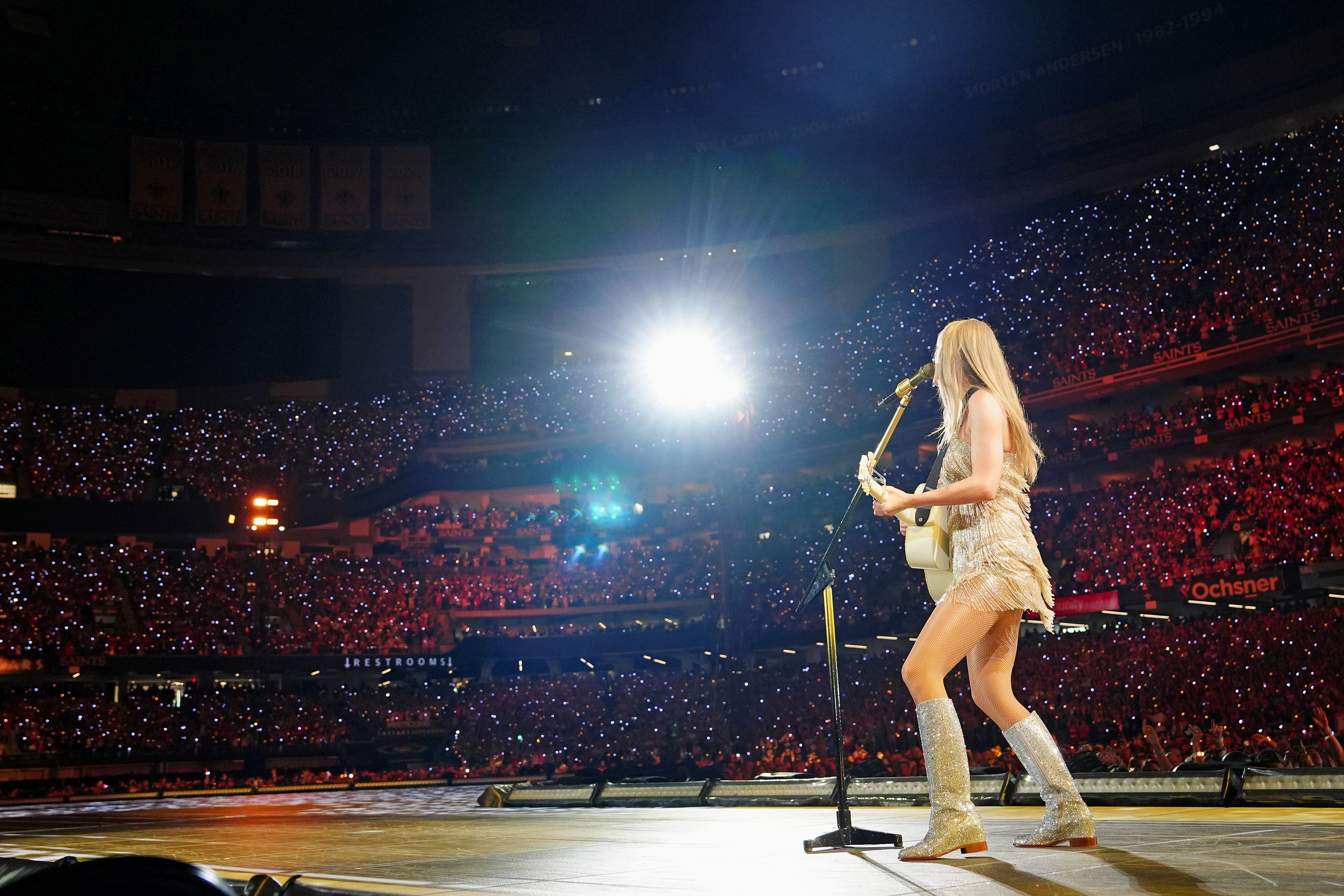 Photo shows Taylor Swift on stage in the Superdome.