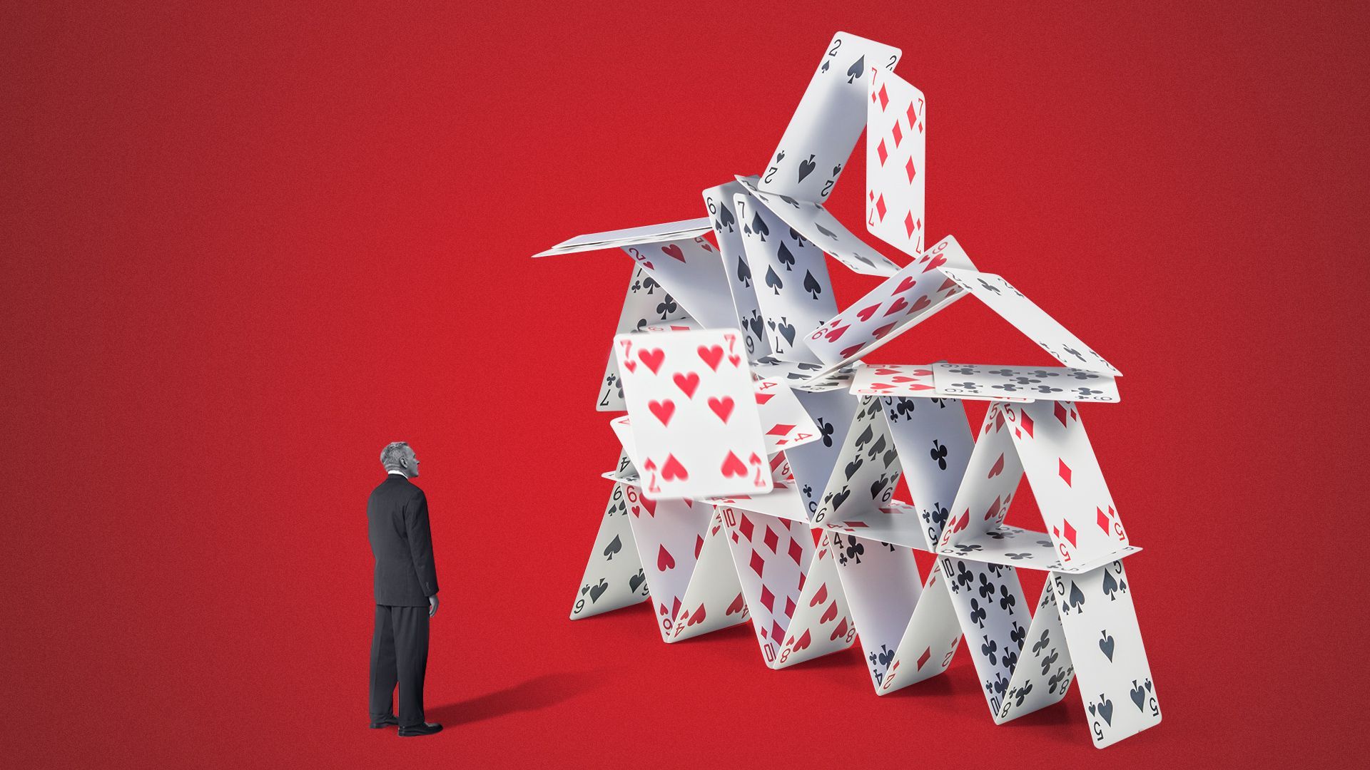 Photo illustration of Kevin McCarthy standing looking up at a collapsing house of cards. 