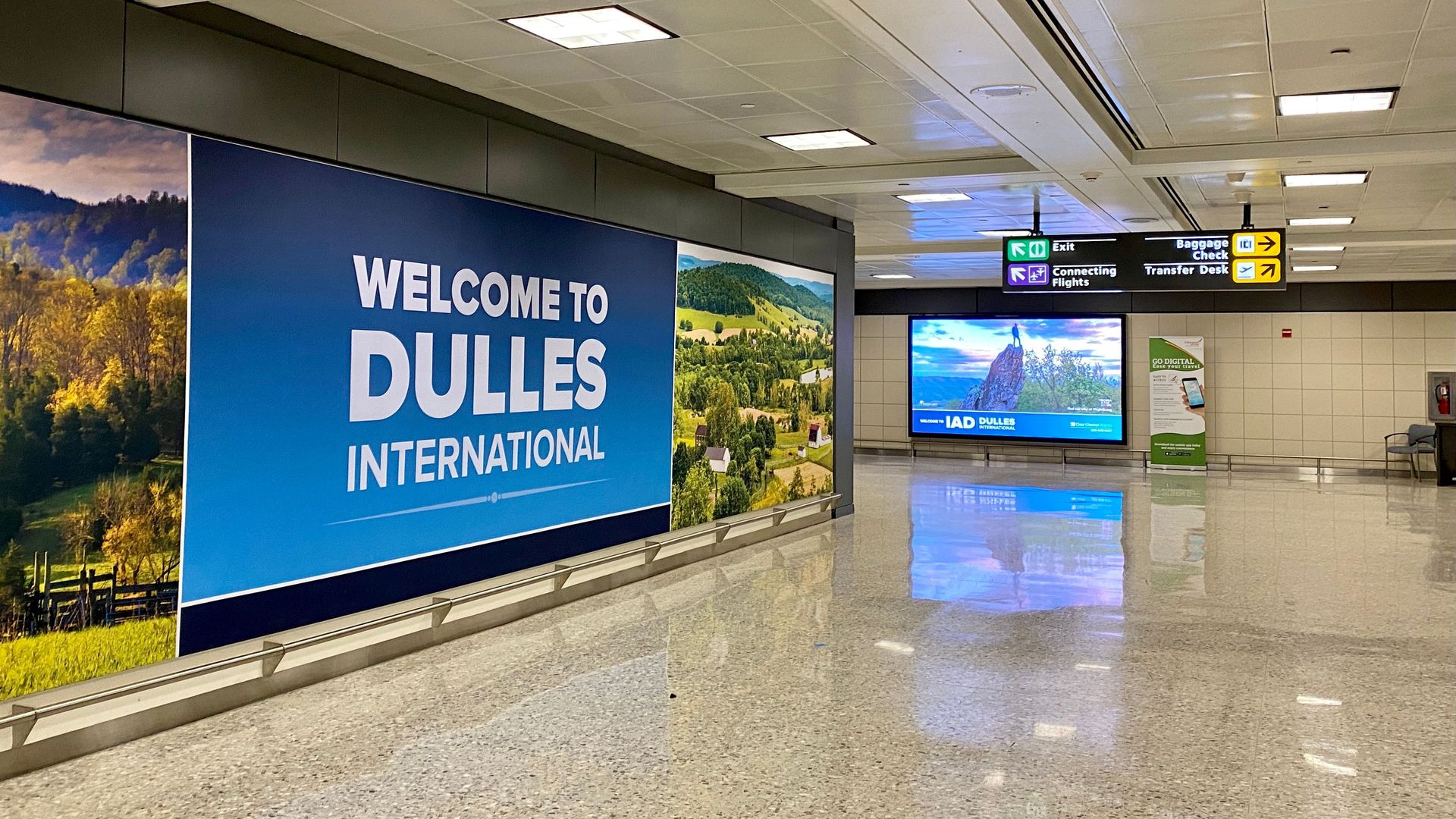 A sign welcomes travelers as they arrive at Washington Dulles International Airport (IAD) on November 19, 2020. - The US government cautions Americans against travelling for the Thanksgiving holiday next week, saying: "It's not a requirement. It's a strong recommendation." (Photo by Daniel SLIM / AF