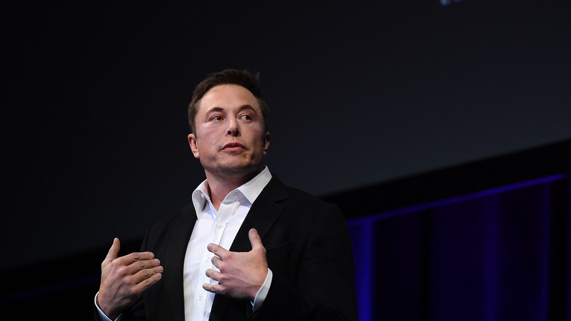 Elon Musk speaking at a conference