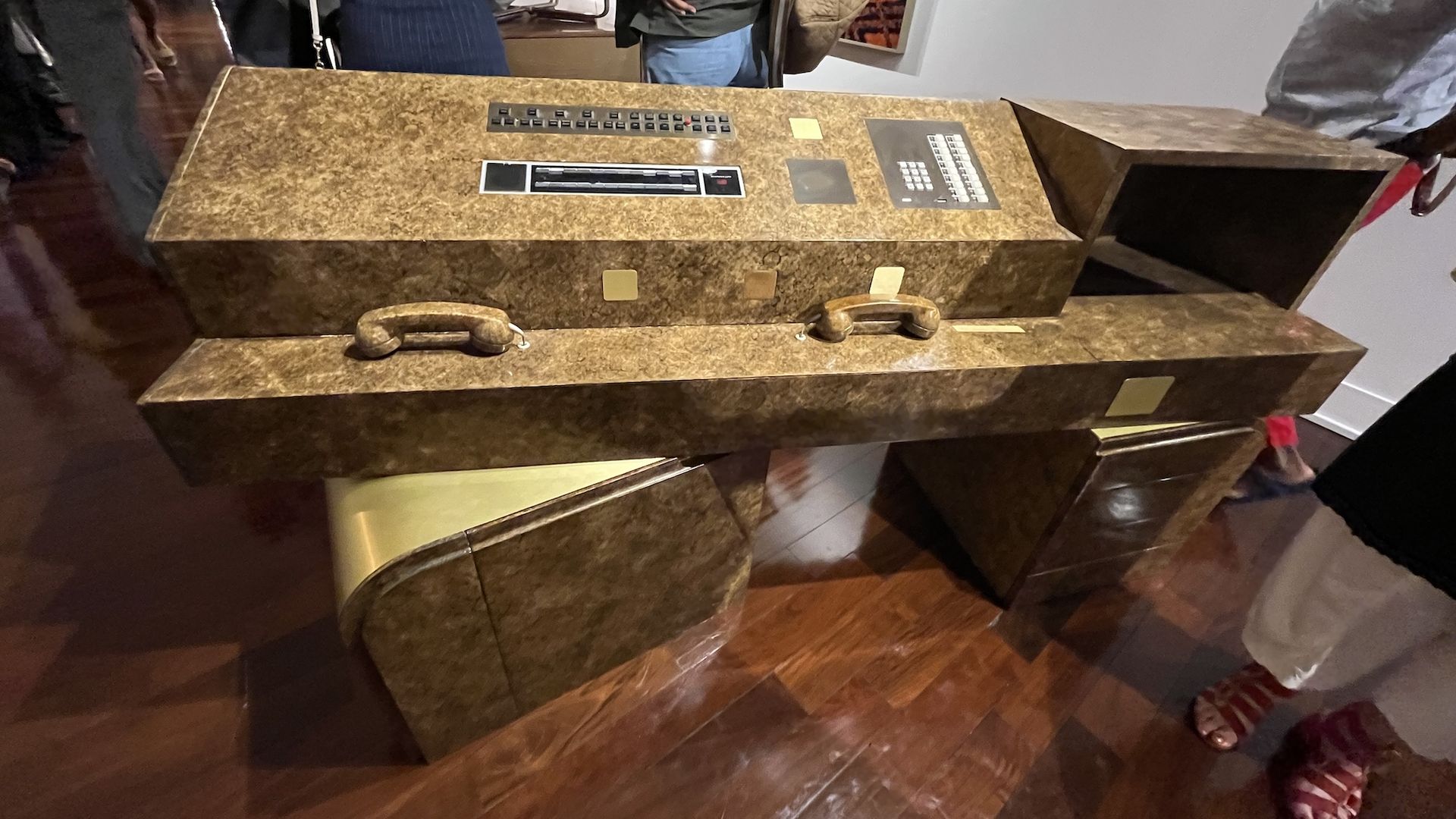 An old burled wood reception desk.