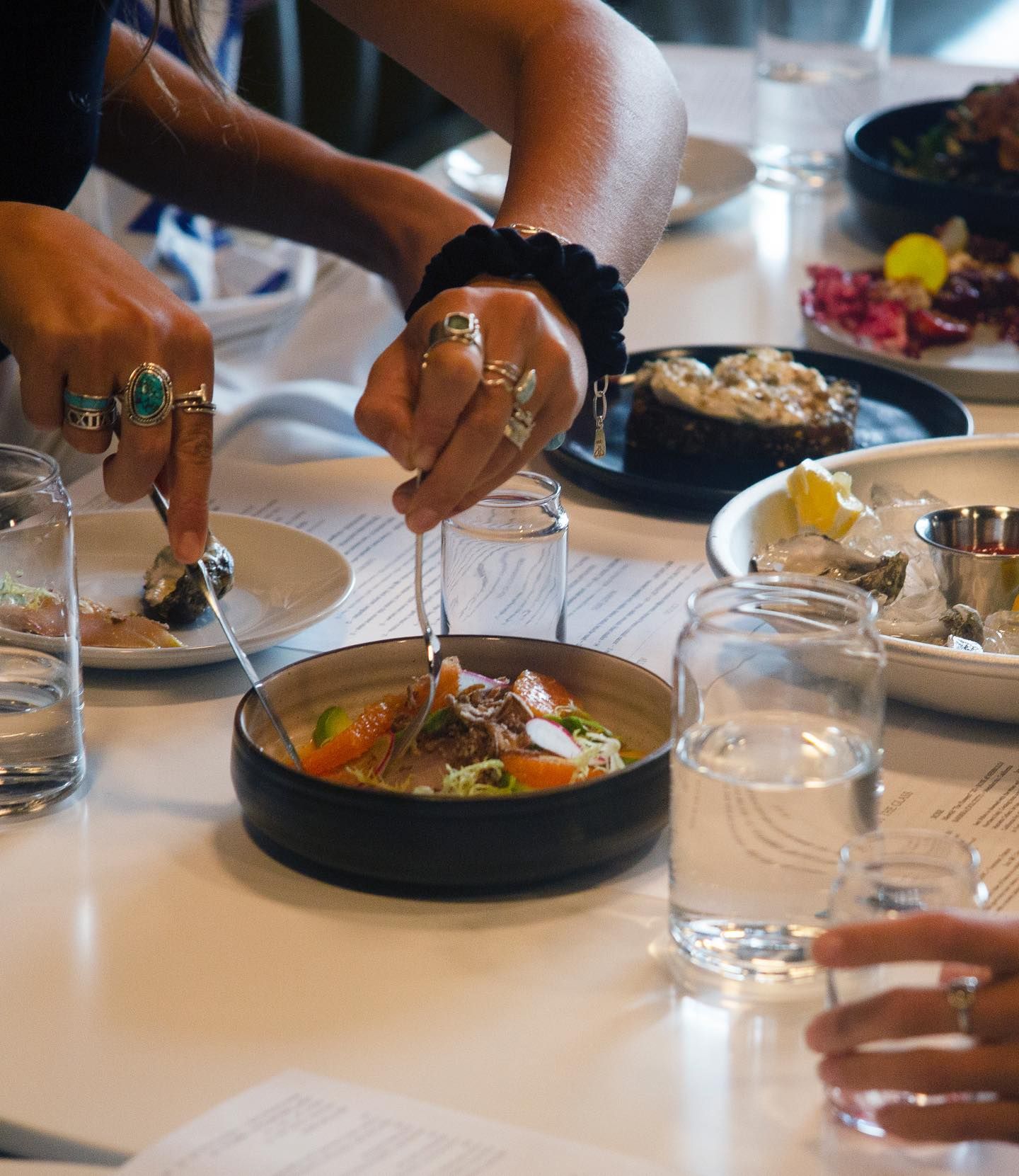 Hands reach for food at Pago.