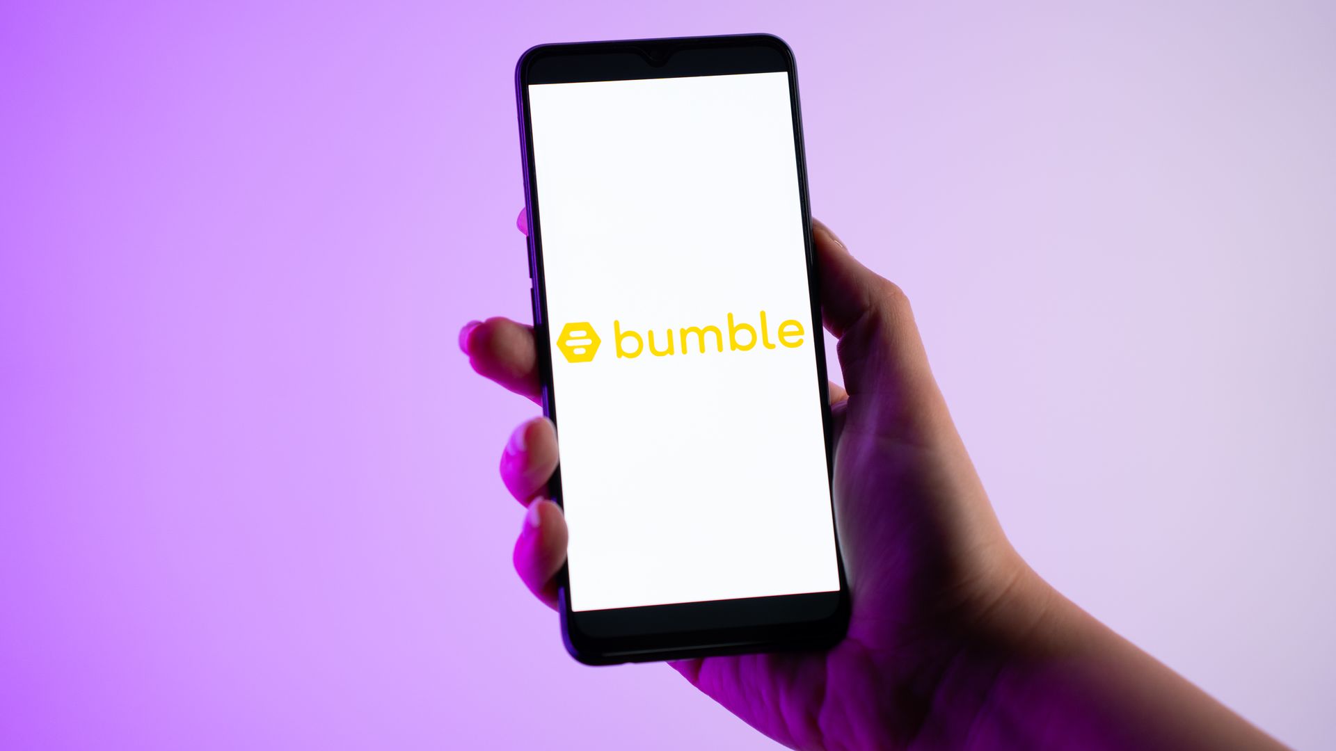 A person is holding a mobile phone with the Bumble dating app logo on its screen, in Athens, Greece, on 31 January 2024