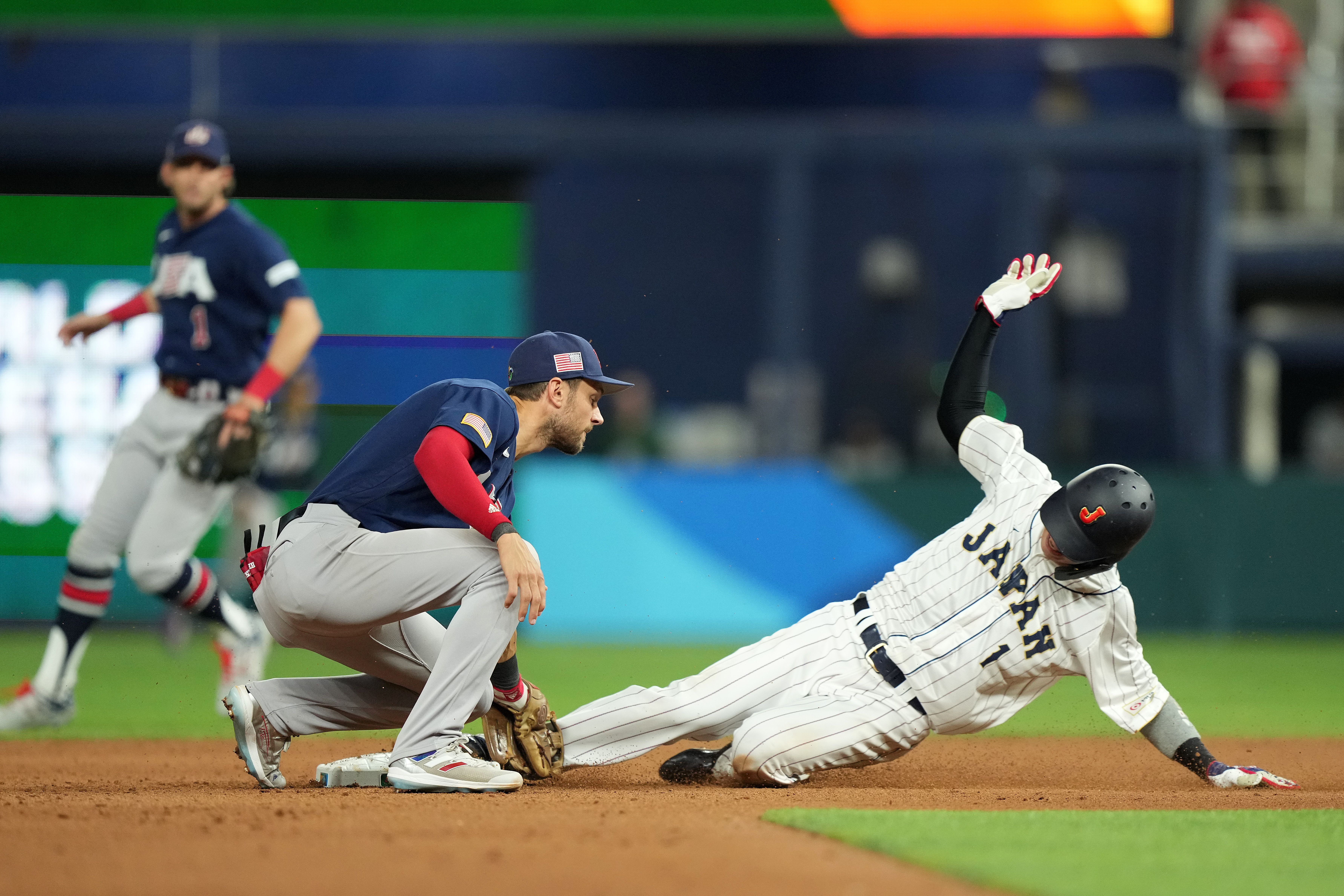 Tetsuto Yamada #1 of Team Japan steals second bae as Trea Turner #8 of Team USA attempts to make the tag in the eighth inning during the World Baseball Classic Championship on March 21, 2023 in Miami.