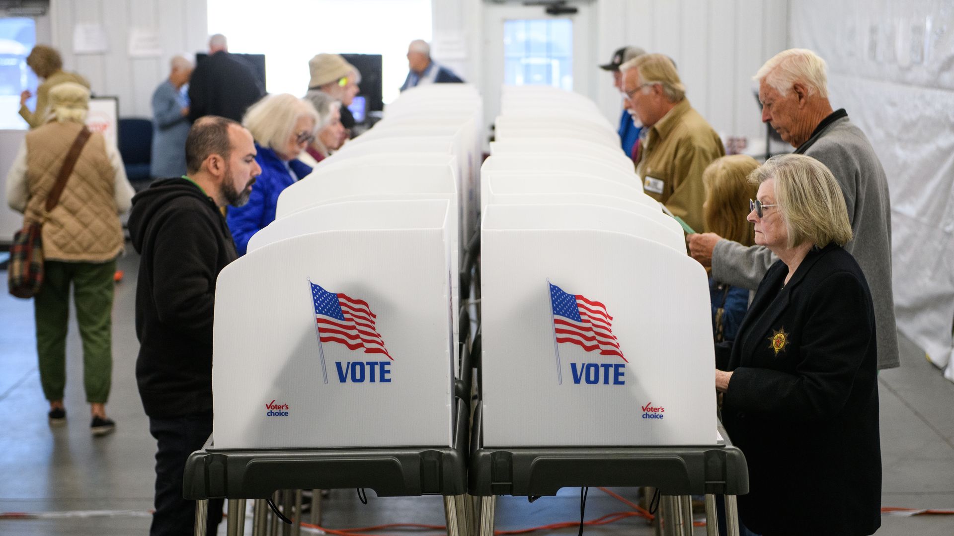HENDERSONVILLE, NORTH CAROLINA - OCTOBER 17: Voters make selections at their voting booths inside an early voting site on October 17, 2024 in Hendersonville, North Carolina. Several counties effected by Hurricane Helene saw a large turnout of residents for the first day of early voting in Western No