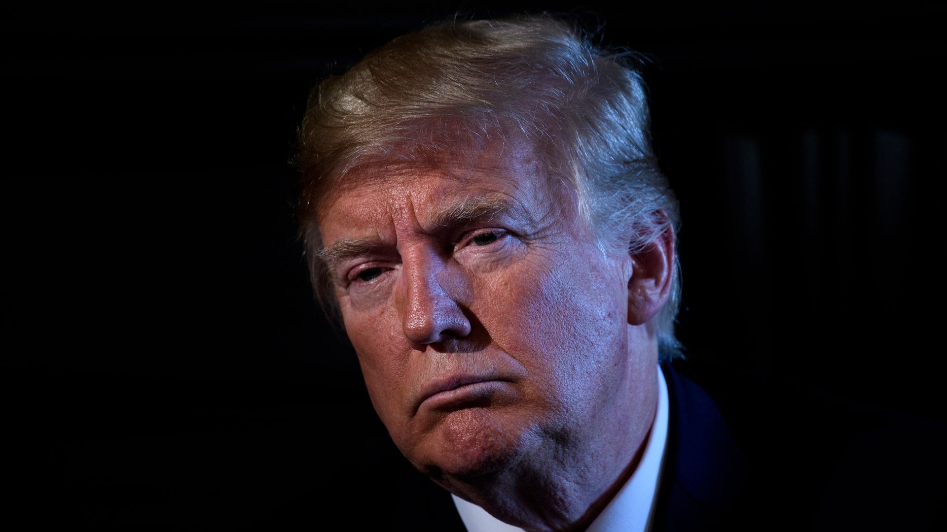 President Donald Trump chairs a meeting with administration and state officials on prison reform at the Trump National Golf Club August 9.
