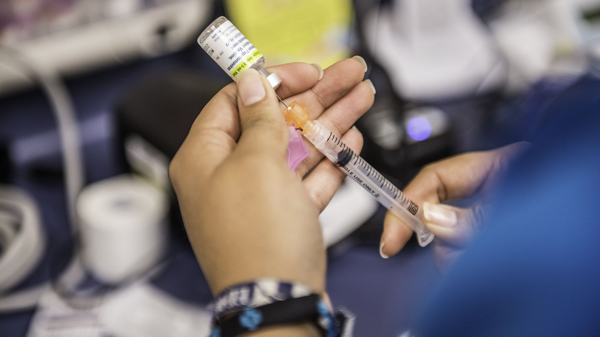 Certified medical assistant Karla Huerta fills a needle with the drug Gardasil, used for HPV vaccinations.