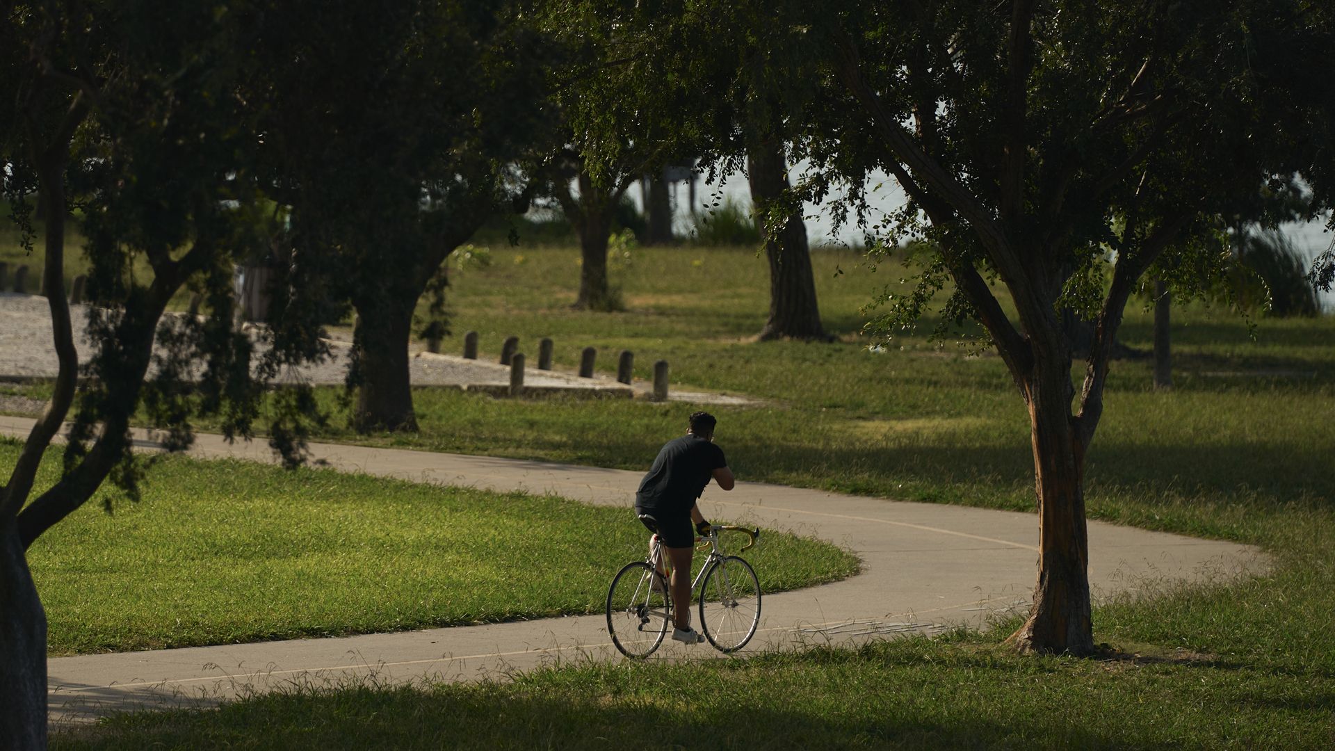 A cyclist rides along a trail