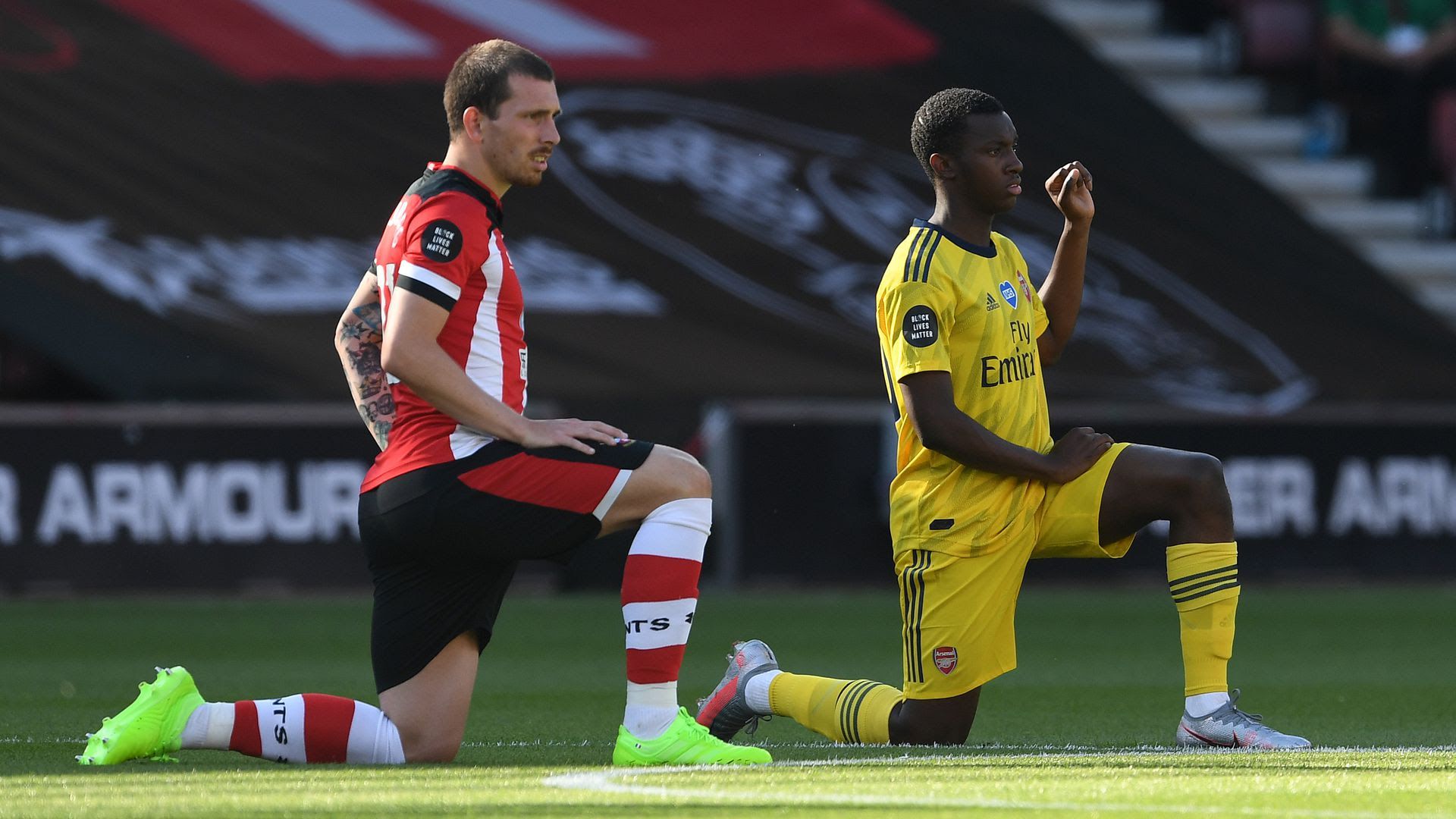 Two soccer players kneeling before a game