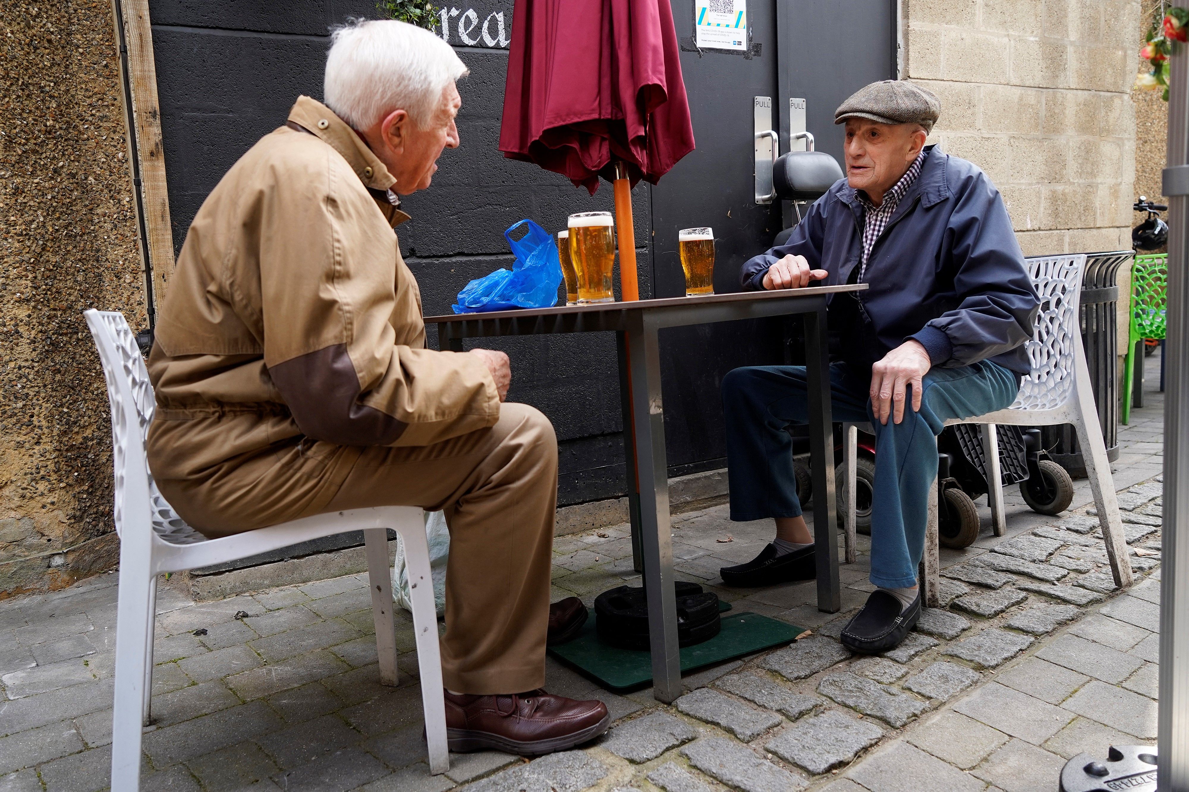 Two people sititng at a table and drinking.