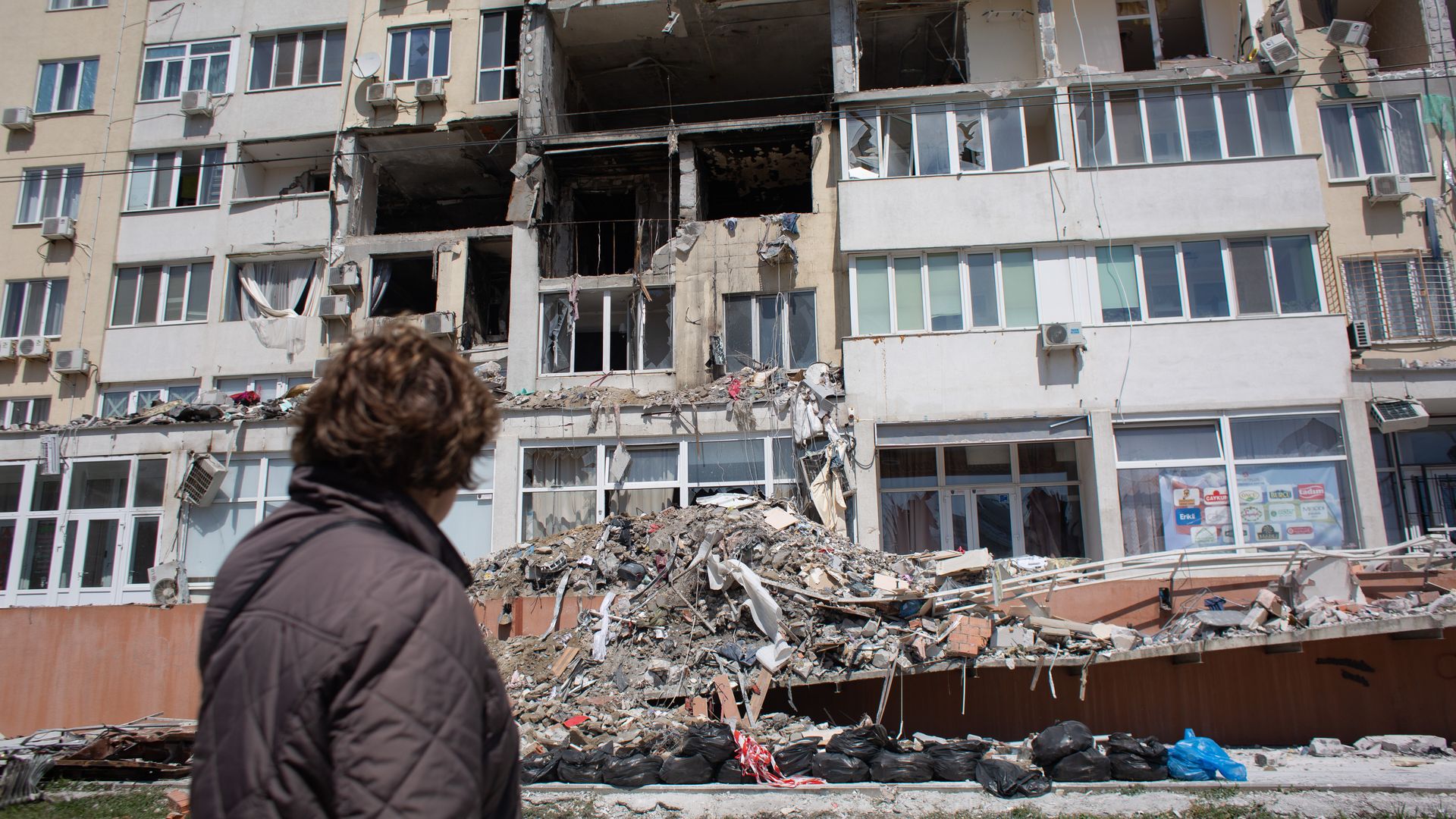 resident whose apartment got destroyed as a result of a missile strike on a residential building, looks at the work of the rescue team on April 25, 2022 in Odessa, Ukraine. 