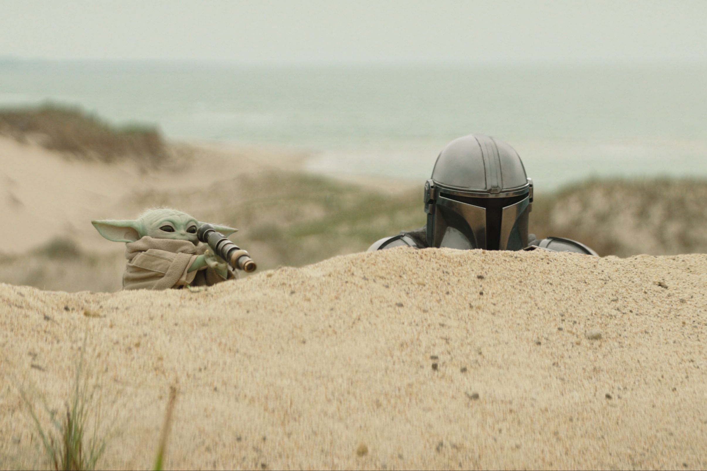 The Mandalorian (Pedro Pascal, right), and Grogu in "Star Wars: The Mandalorian and Grogu."