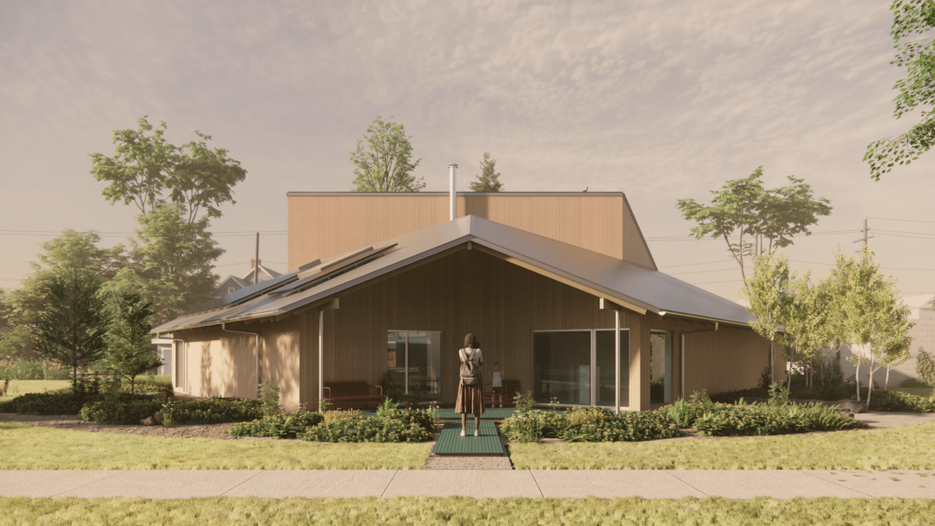 A modern, single-story house with tan wood siding and a sloped metal roof. A woman and child stand on a green stepping-stone path at the entrance, surrounded by trees, shrubs, and a pastel sky.