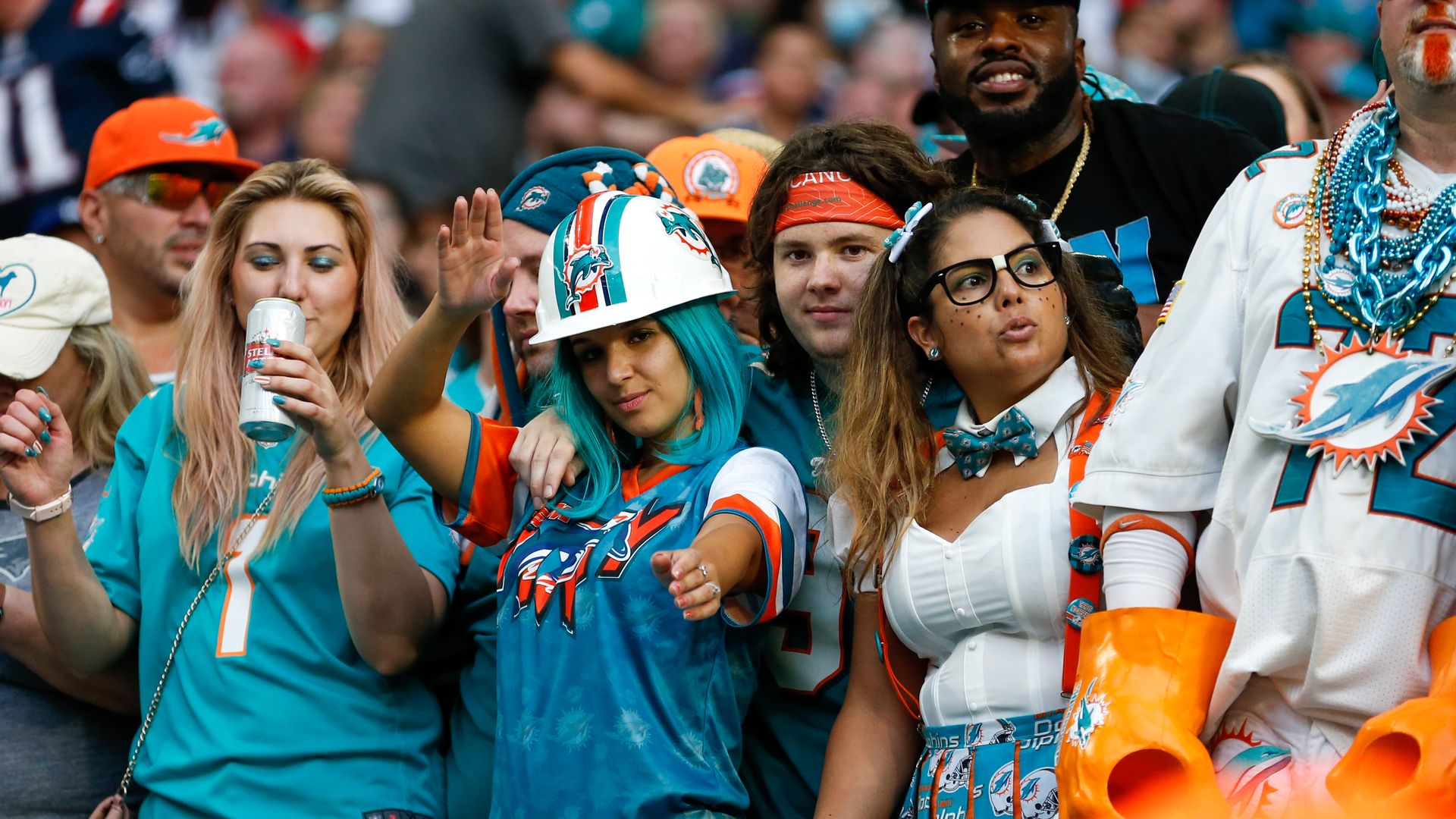 Miami Dolphins fans pose for a photo at Hard Rock Stadium during a Dolphins game.