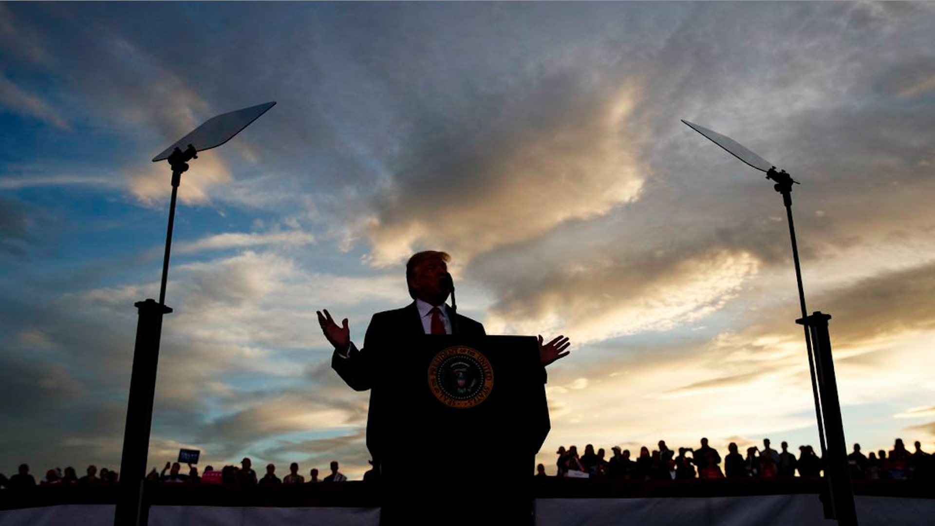President Trump speaks at a podium during a rally outside in Montana