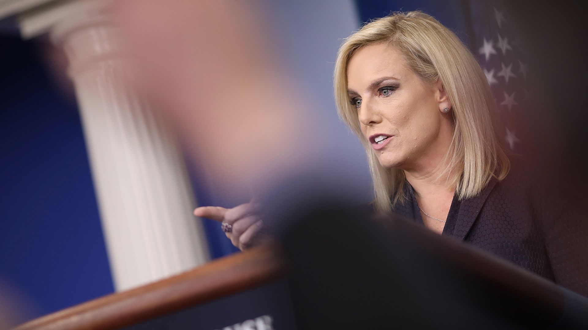 Nielsen at the podium in the briefing room