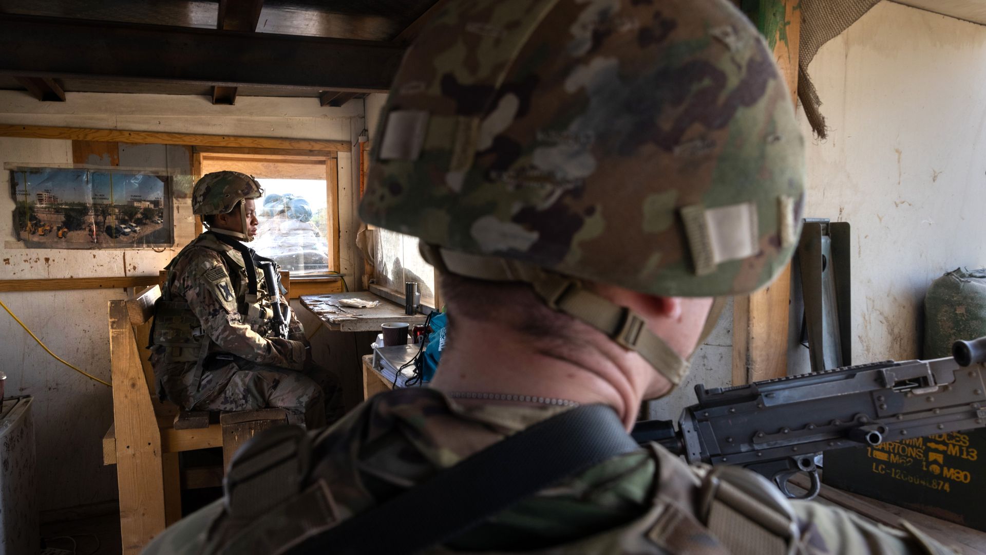 Photo of two U.S. Army soldiers stationed in a guardhouse