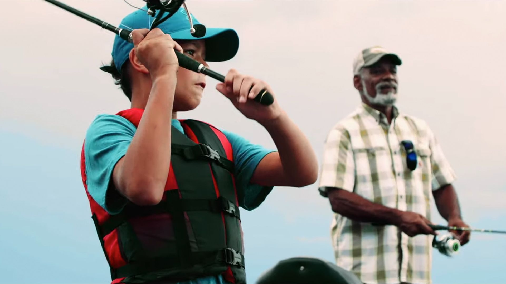 Image of a boy and a man fishing in a Super Bowl ad