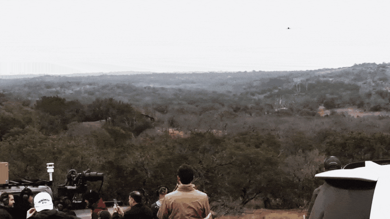 An automated gun turret shoots down a small drone in the Texas scrublands.