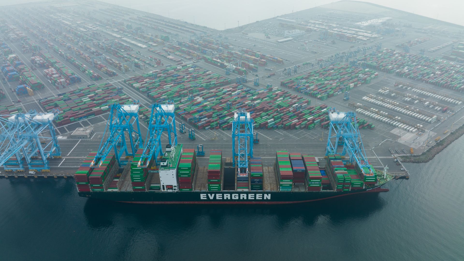 SAN PEDRO, CALIFORNIA - JANUARY 19: Aerial view of containers and cargo ships at the Port of Los Angeles on January 19, 2022 in San Pedro, California