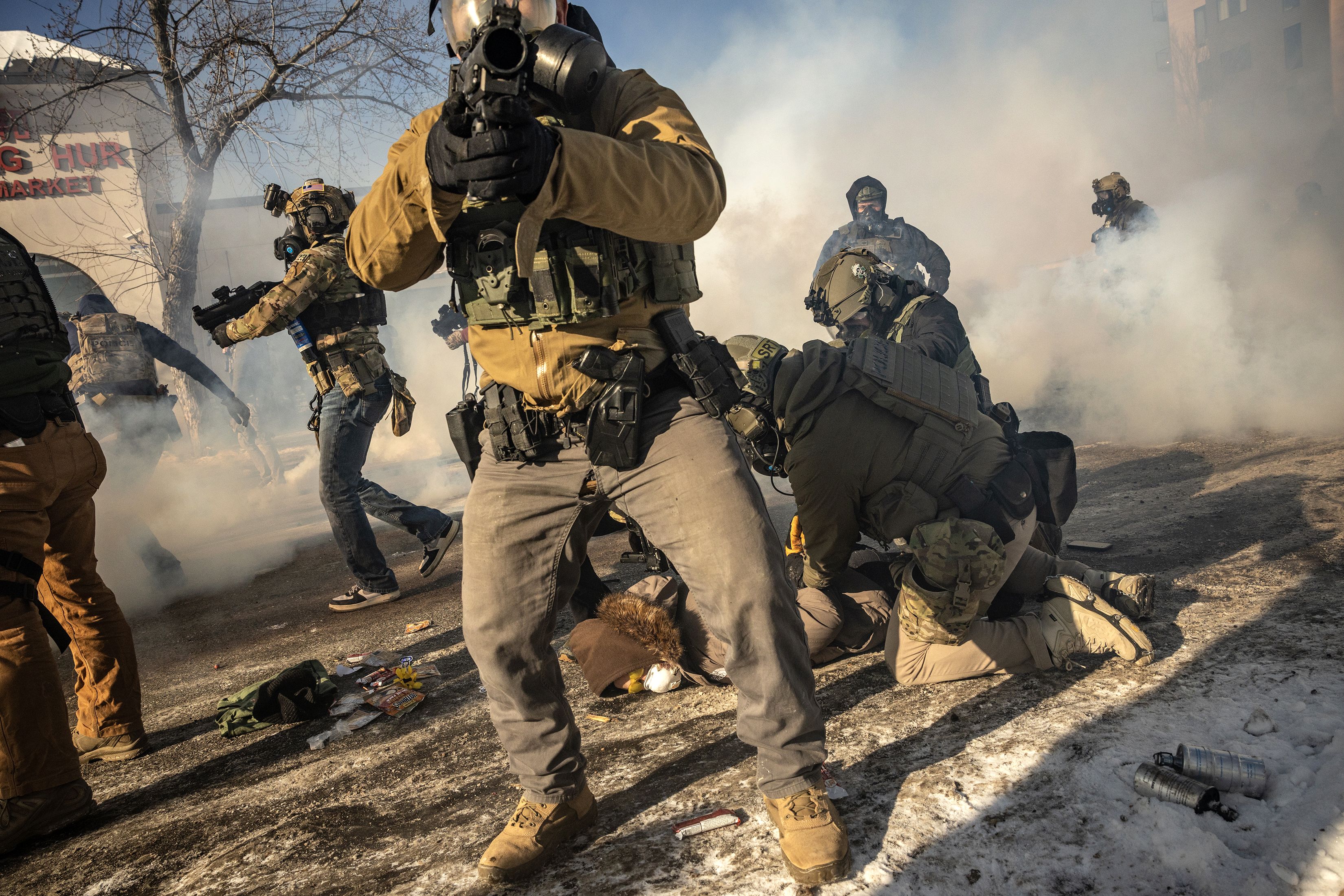 Federal agents confront protestors in Minneapolis, near the intersection of 26th Street and Nicollet Avenue in Minneapolis, where federal law enforcement agents shot a person earlier on Saturday, Jan. 24, 2026. The shooting two weeks after an ICE agent's killing of Renee Good prompted escalating cla