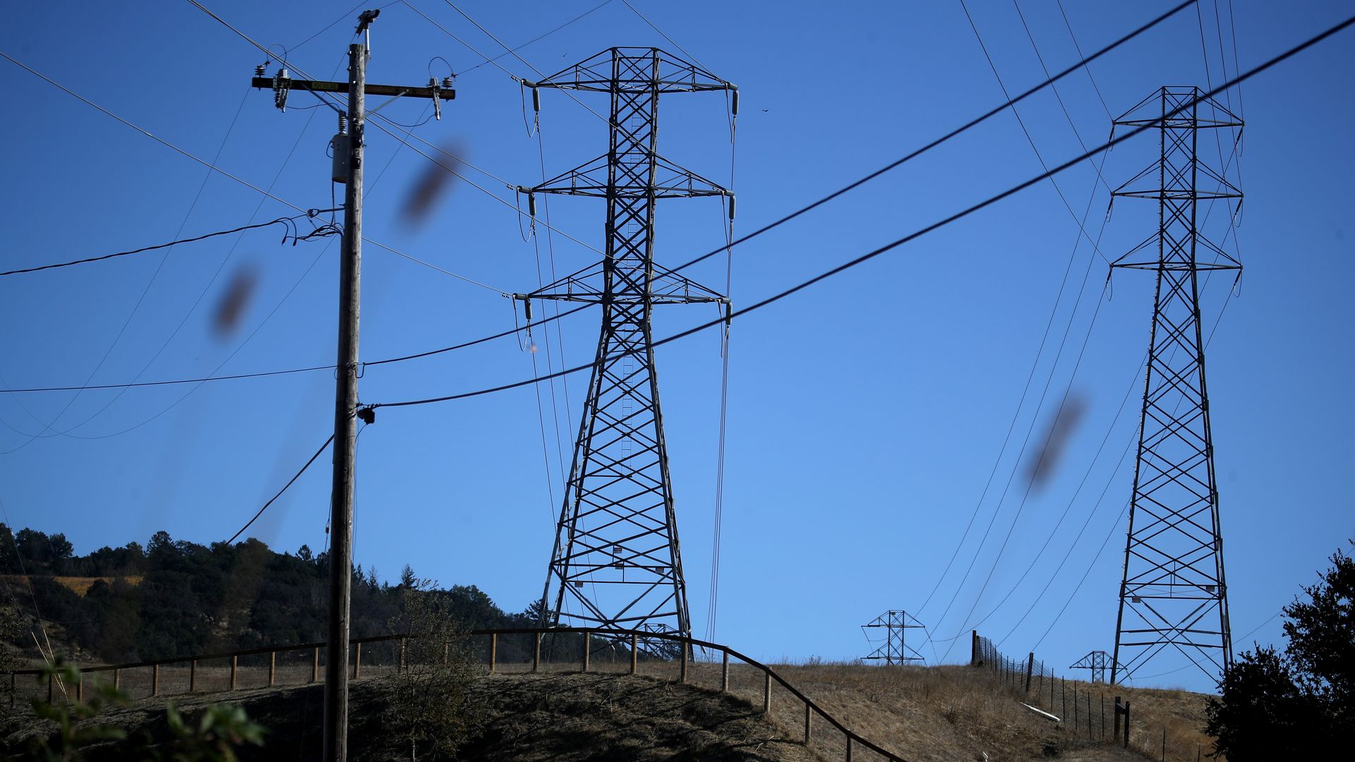 Electric wires and telephone poles on the side of a mountain