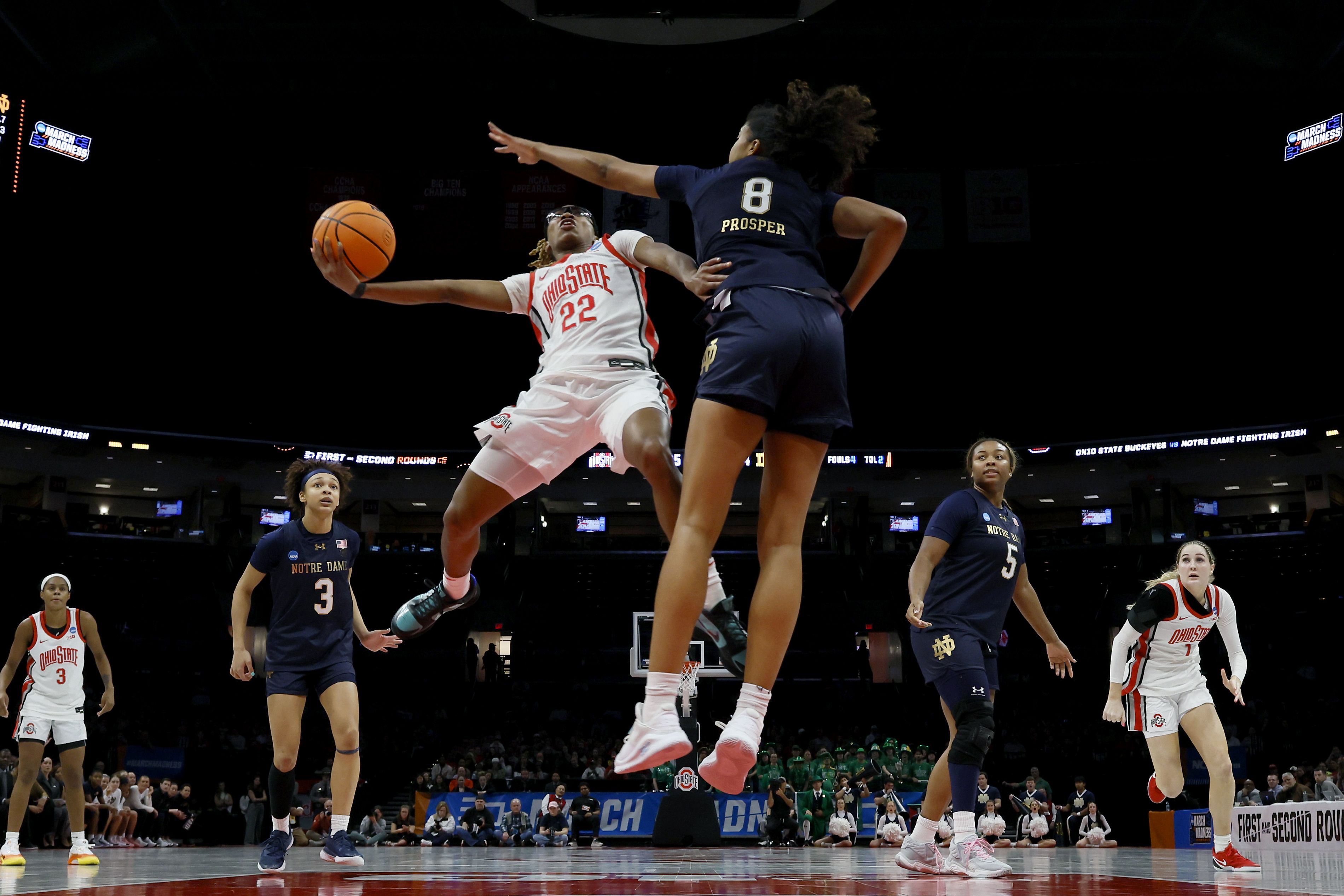 Guard Jaloni Cambridge (22) of the Ohio State Buckeyes drives to the basket as guard Cassandre Prosper (8) of the Notre Dame Fighting Irish defends during a second round game of the 2026 NCAA Women's Basketball Tournament