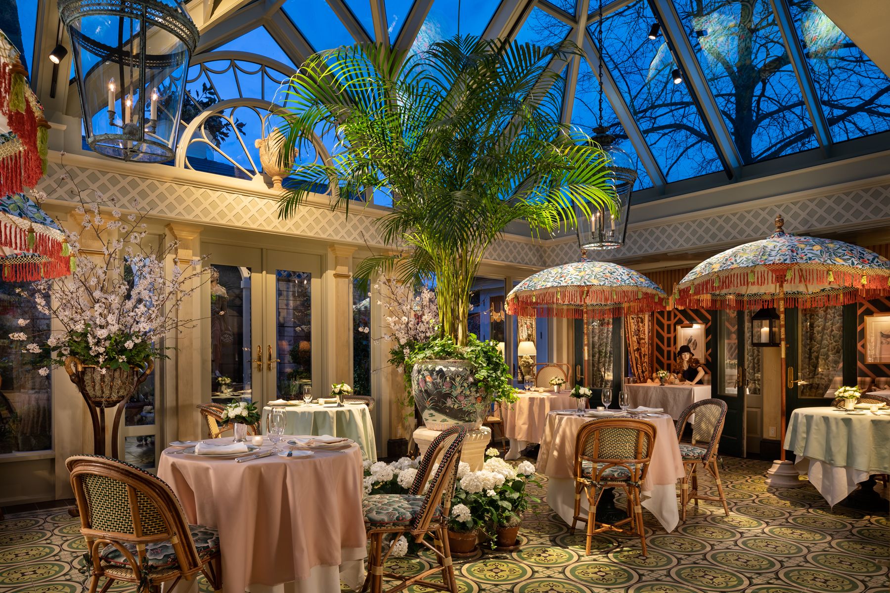 The decadent "conservatory" room at the Inn with umbrellas, palm trees and a skylight dome.
