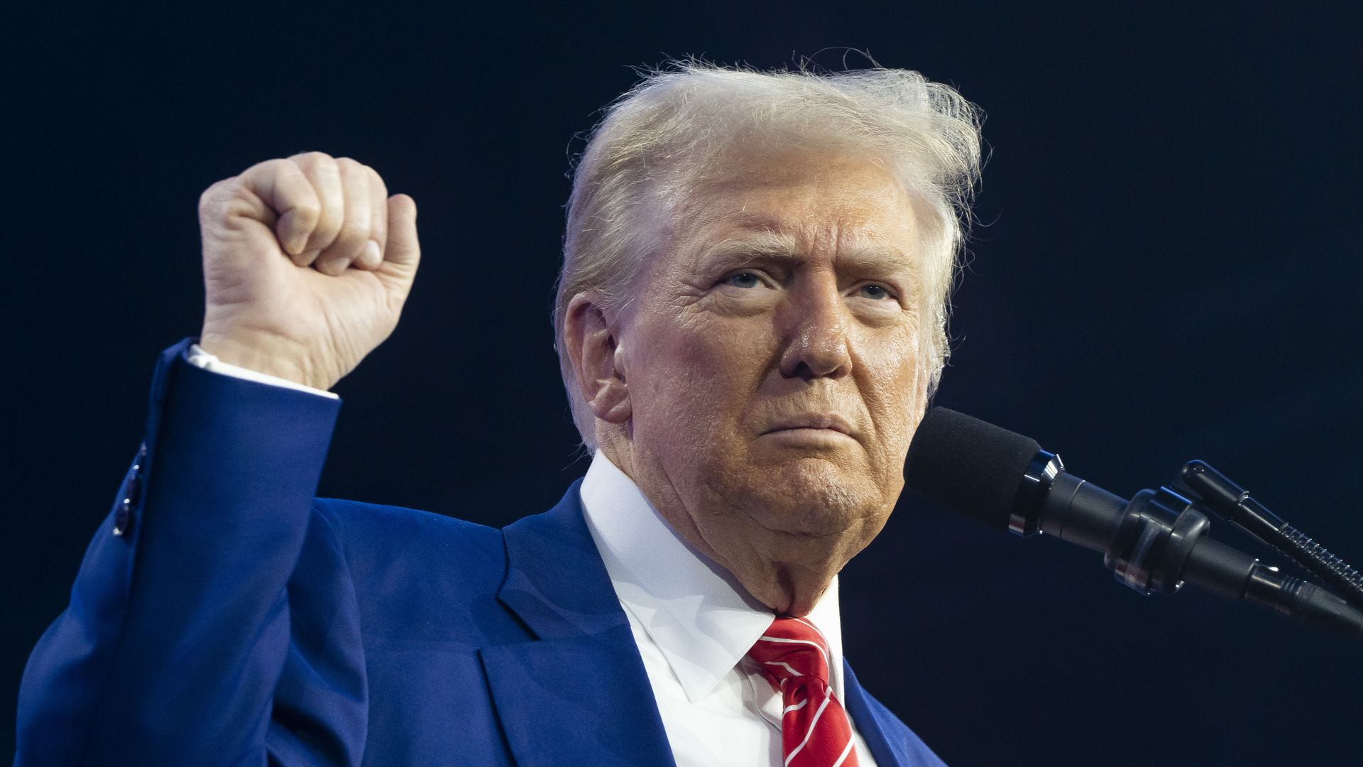 Trump pumps his fist during a speech.