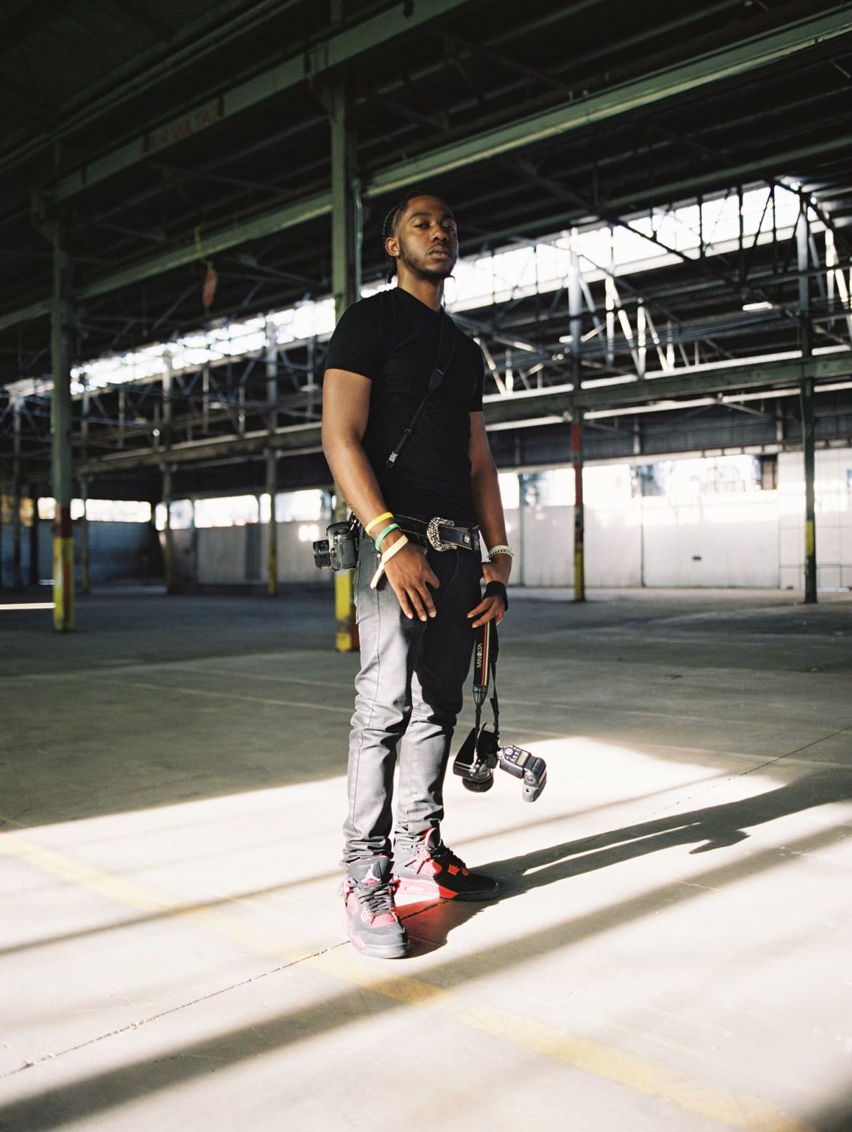 JoJo stands with camera