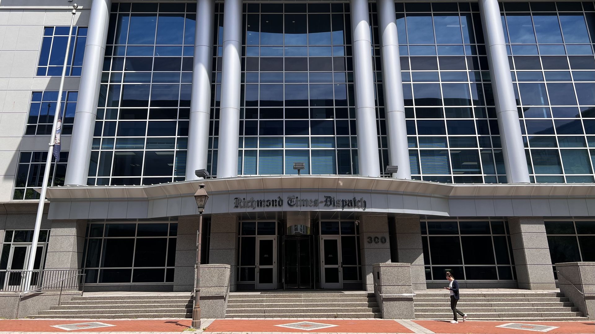 The front of the Richmond Times-Dispatch building which has six pillars and a sign that says "Richmond Times-Dispatch" in front of it