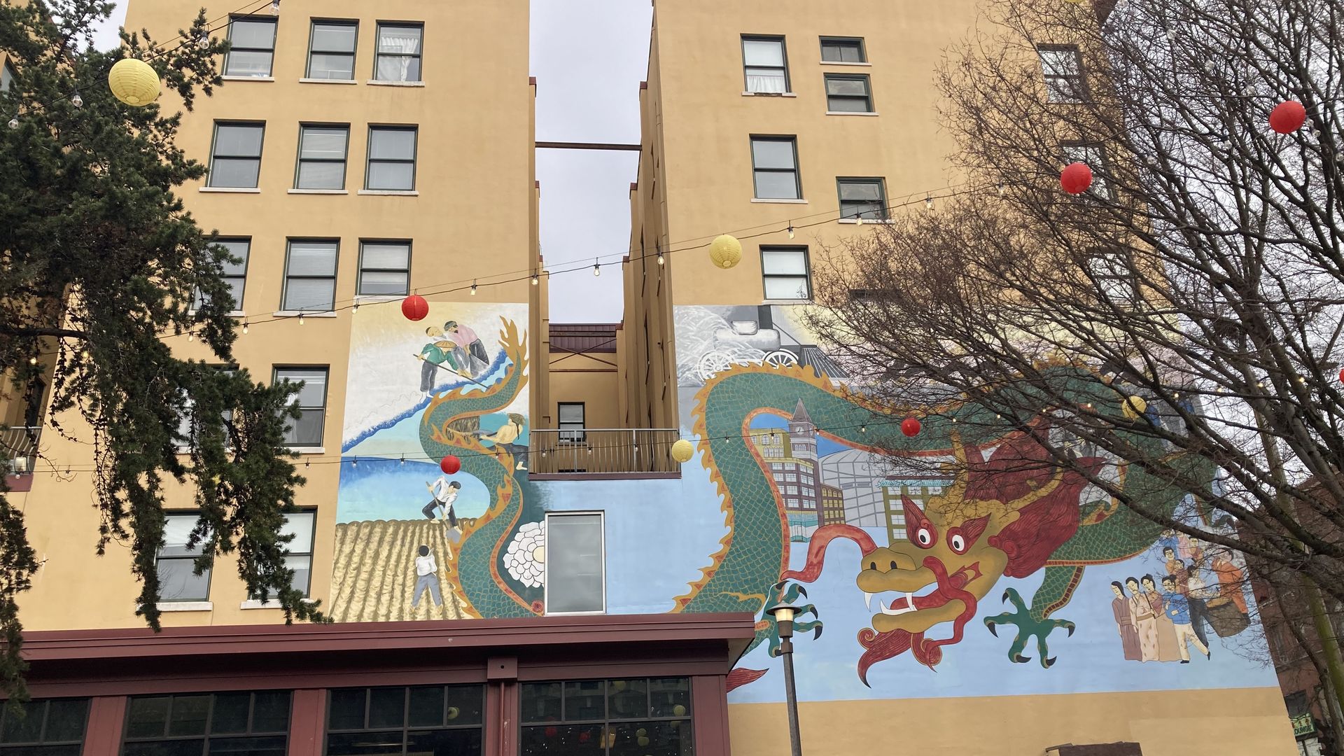 A mural of a dragon is painted on the back of a building in Seattle. 