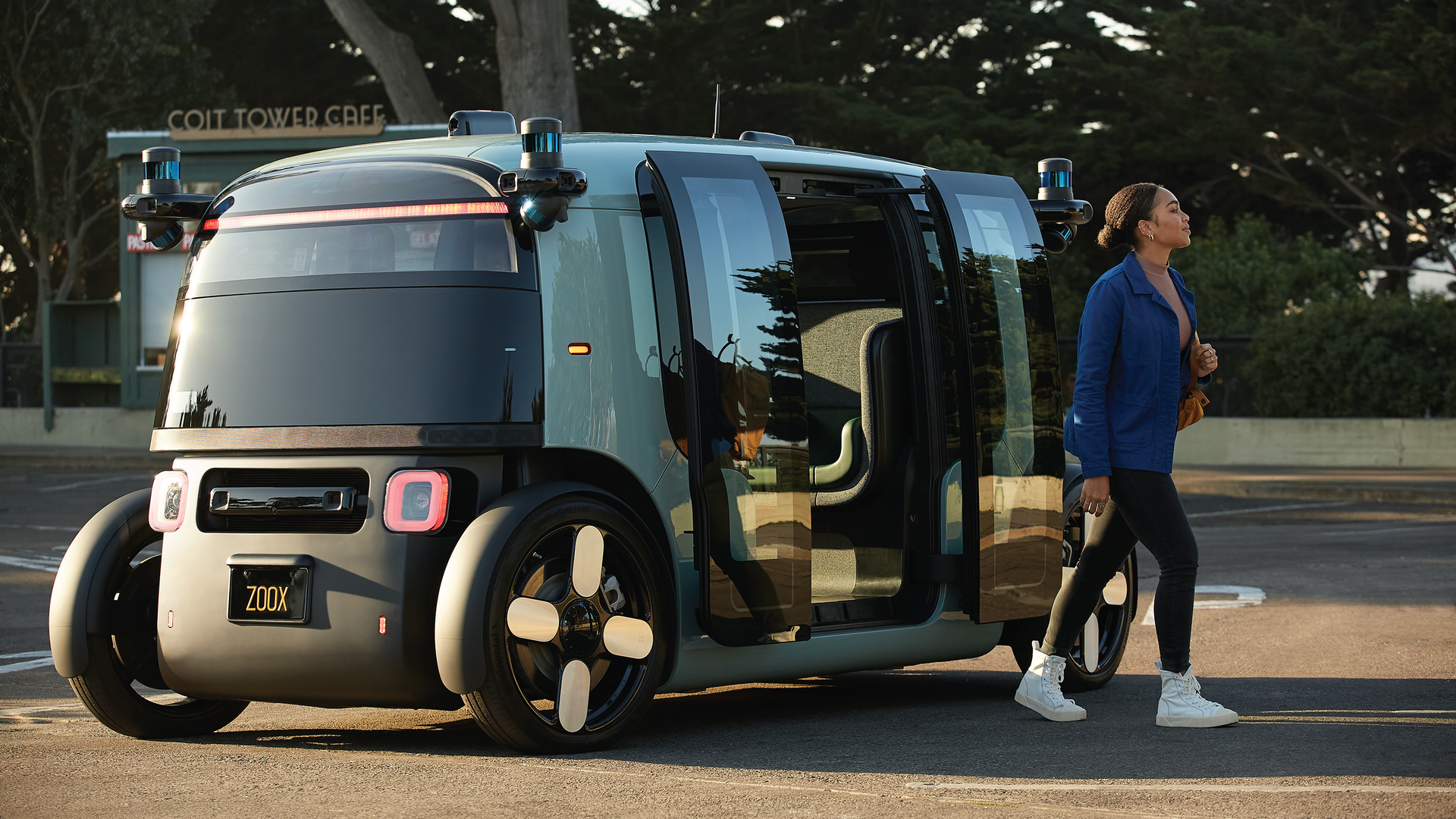 Image of a woman exiting Zoox's robotaxi