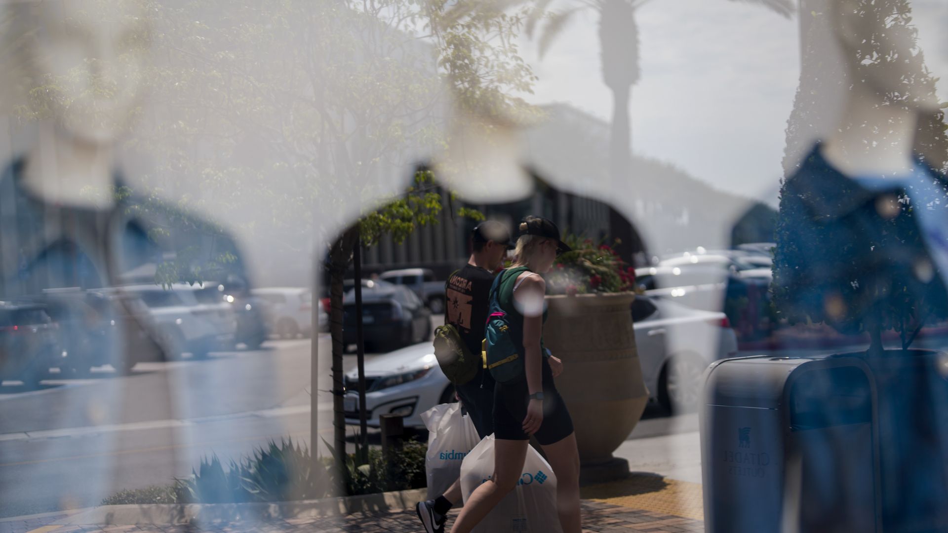 Clothing displayed on mannequins as shoppers carry bags in Los Angeles, California, US, on Tuesday, Aug. 28, 2025.